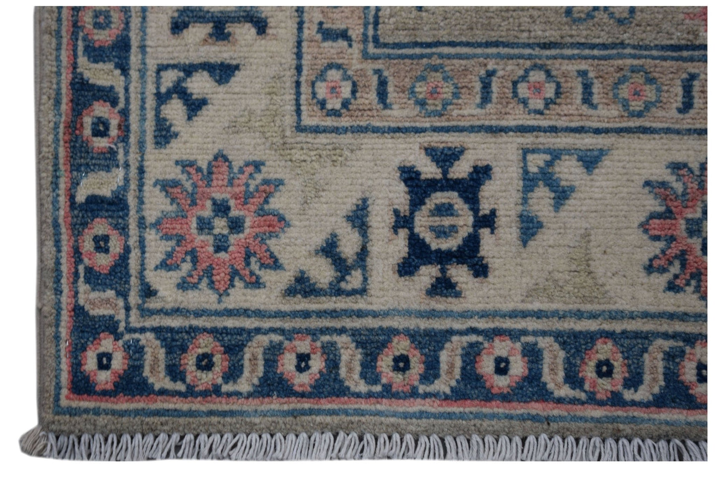 Handmade Afghan Kazakh runner featuring traditional geometric motifs in blue and pink on wool.