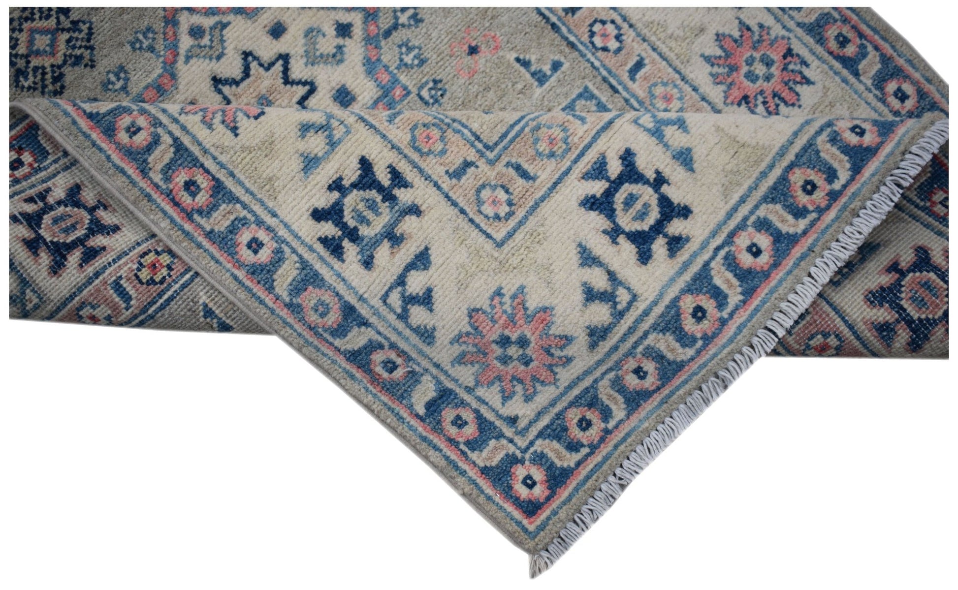 A handmade Afghan Kazakh runner featuring traditional blue and pink geometric motifs on wool.