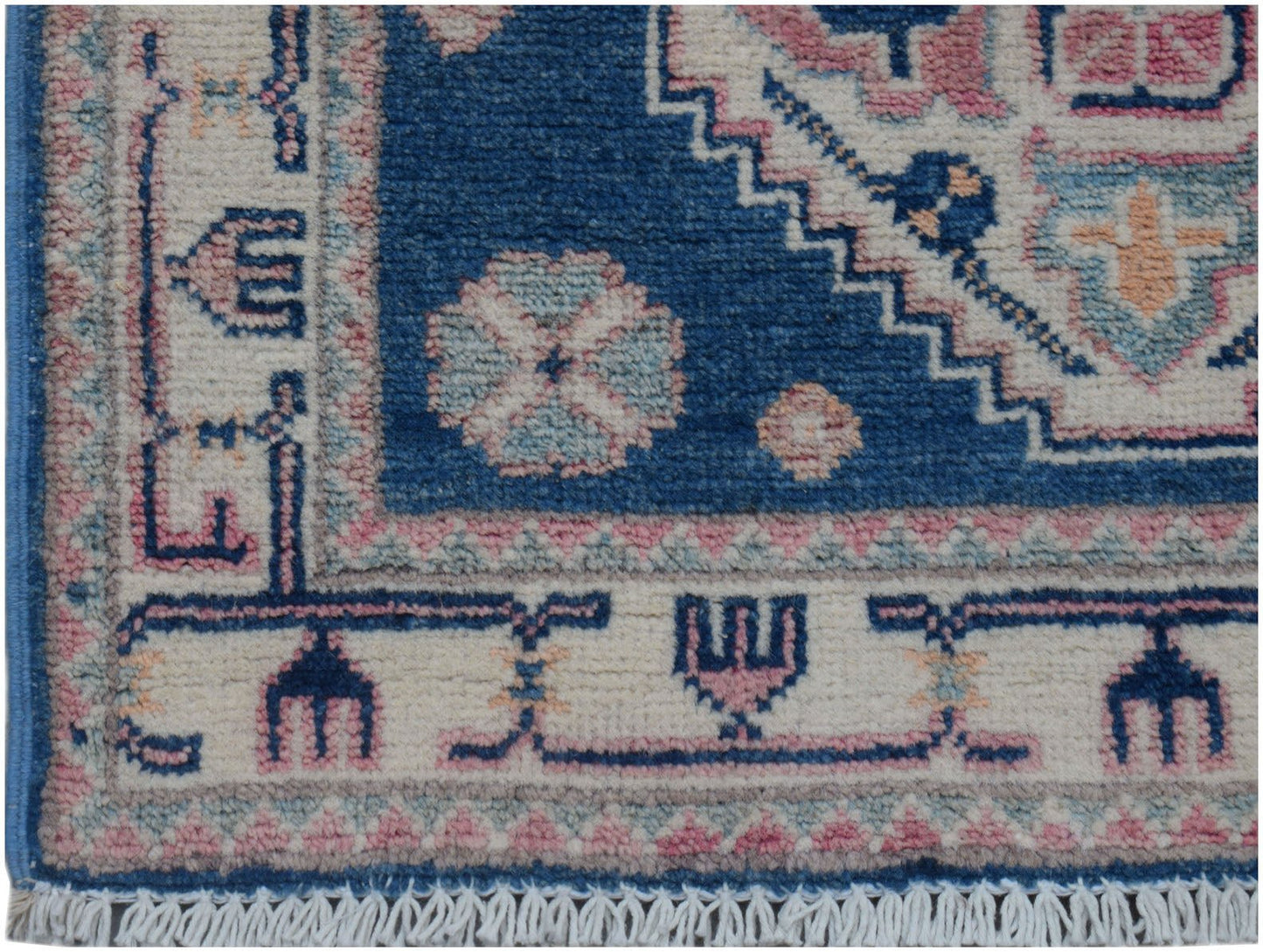 A handmade Afghan Kazakh runner featuring traditional geometric motifs in blue, pink, and cream.