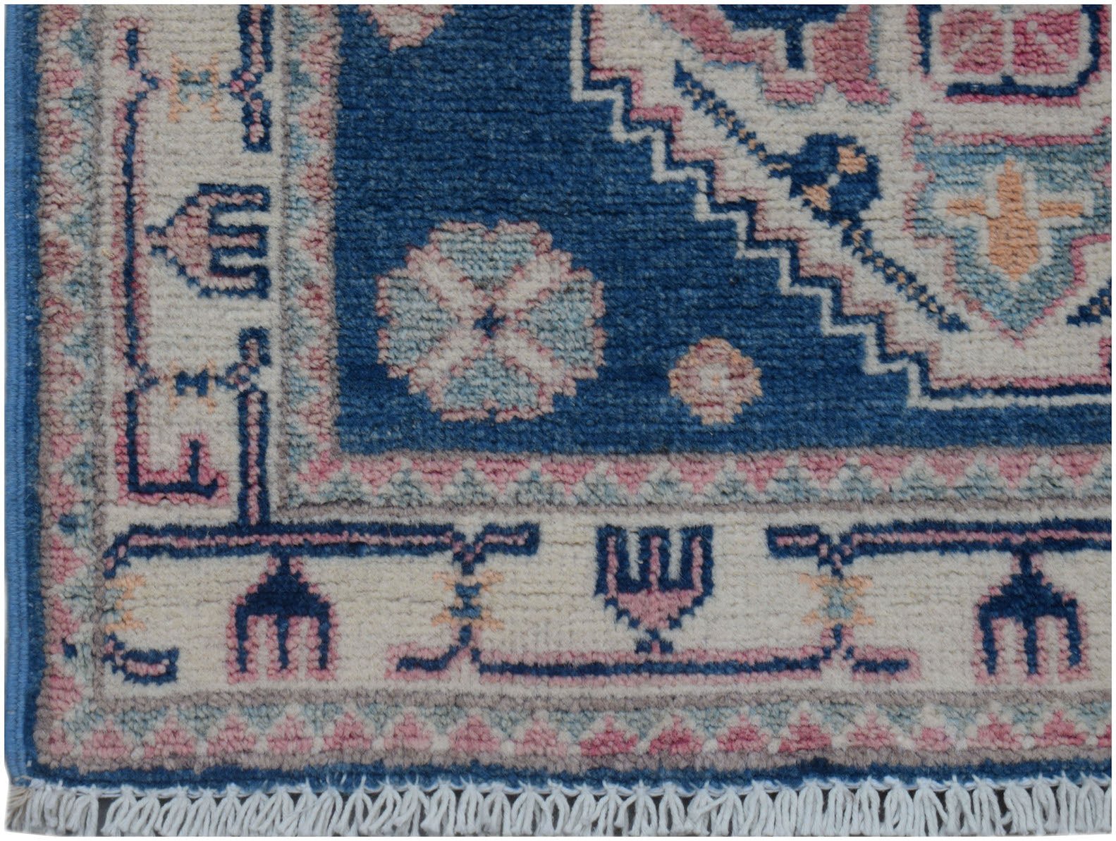 A handmade Afghan Kazakh runner featuring traditional geometric motifs in blue, pink, and cream.