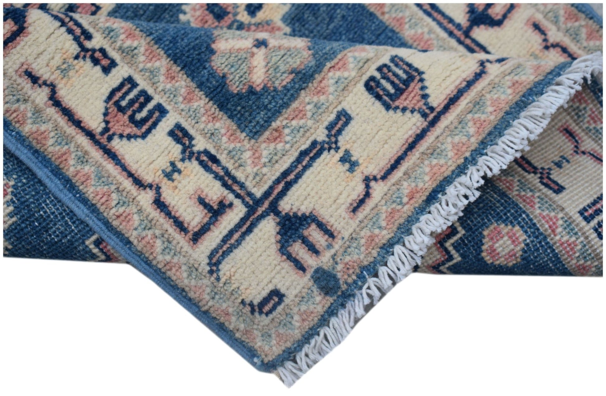 A handmade Afghan Kazakh runner featuring traditional blue and cream geometric patterns.