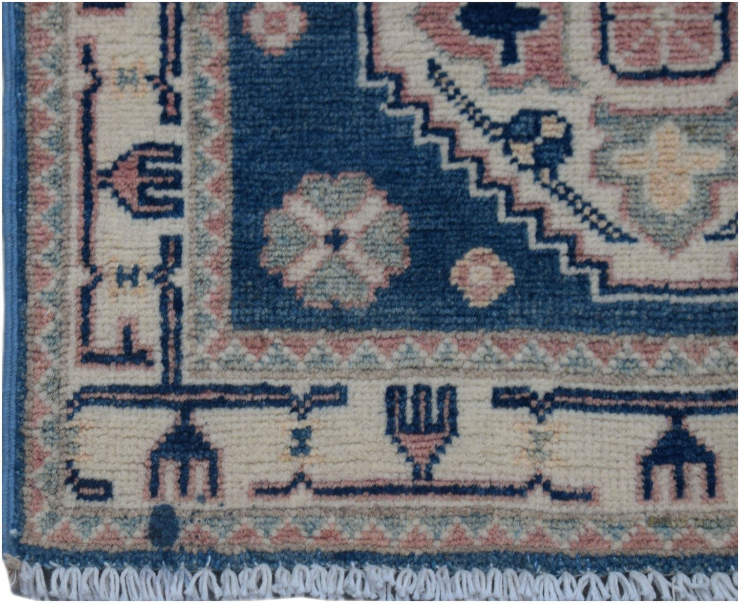 A handmade Afghan Kazakh runner featuring traditional geometric motifs in blue, pink, and cream.