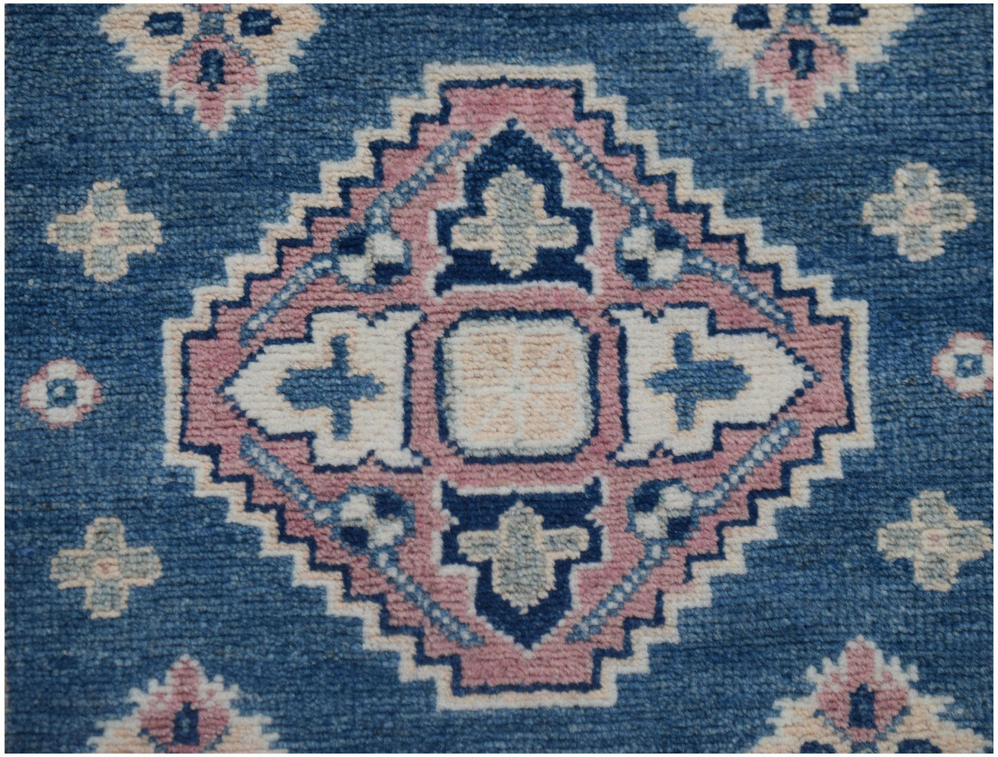 Handmade Afghan Kazakh runner featuring a geometric diamond pattern in blue, pink, and cream.