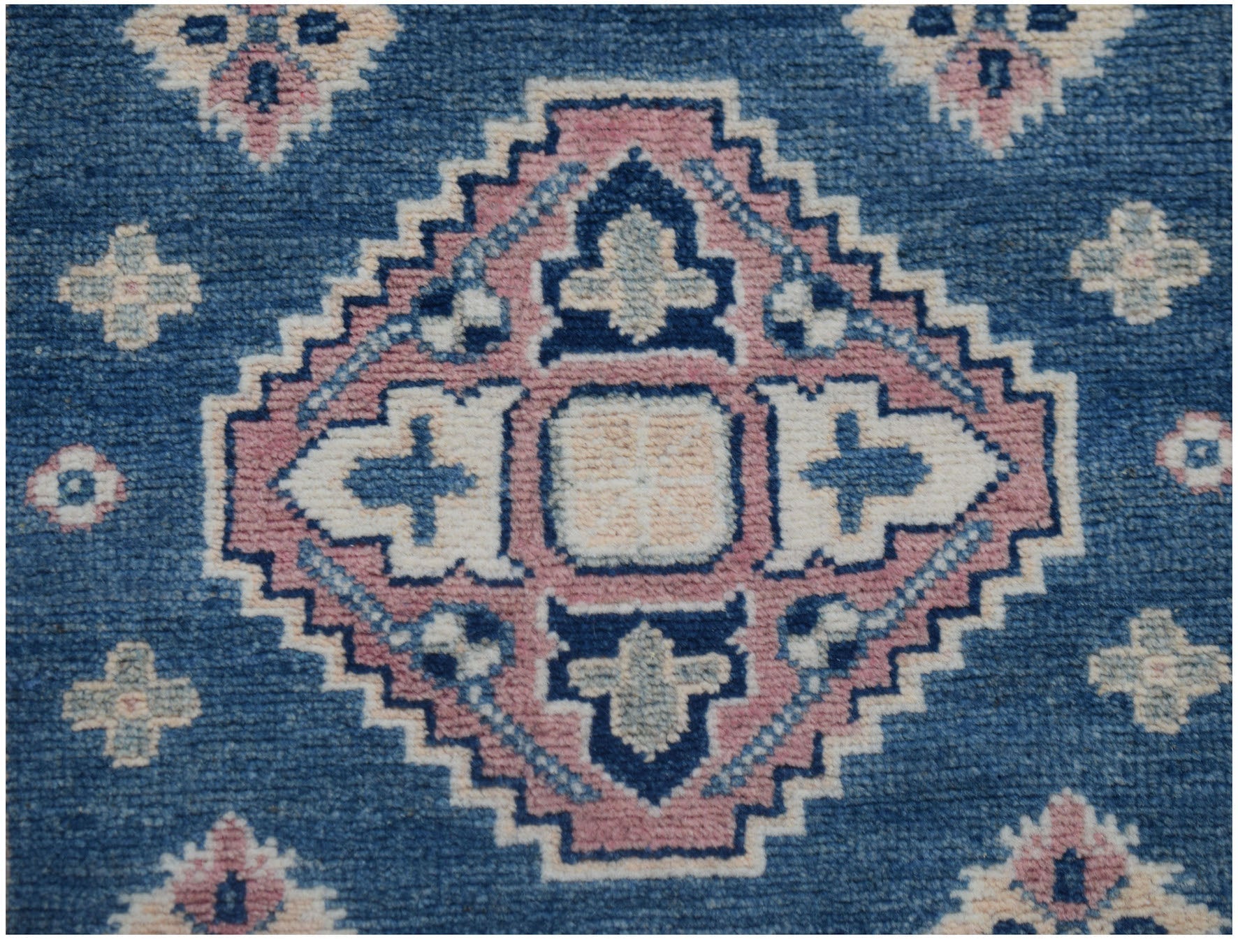 Handmade Afghan Kazakh runner featuring a geometric diamond pattern in blue, pink, and cream.