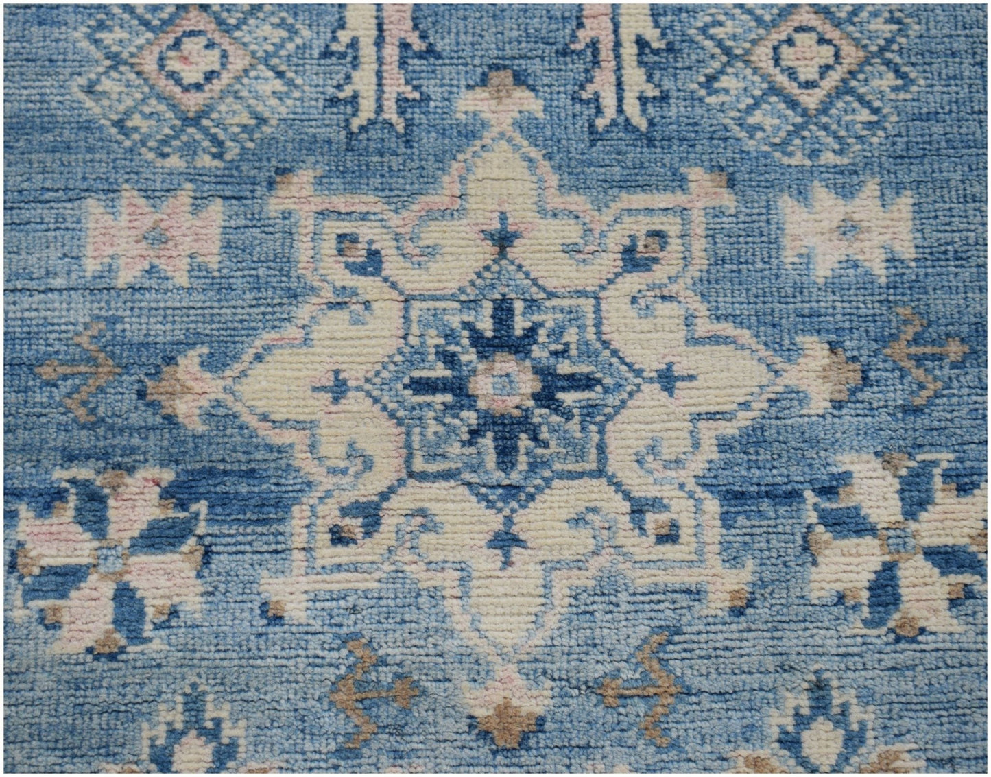 Handmade Afghan Kazakh runner rug featuring a traditional blue and cream geometric medallion design.
