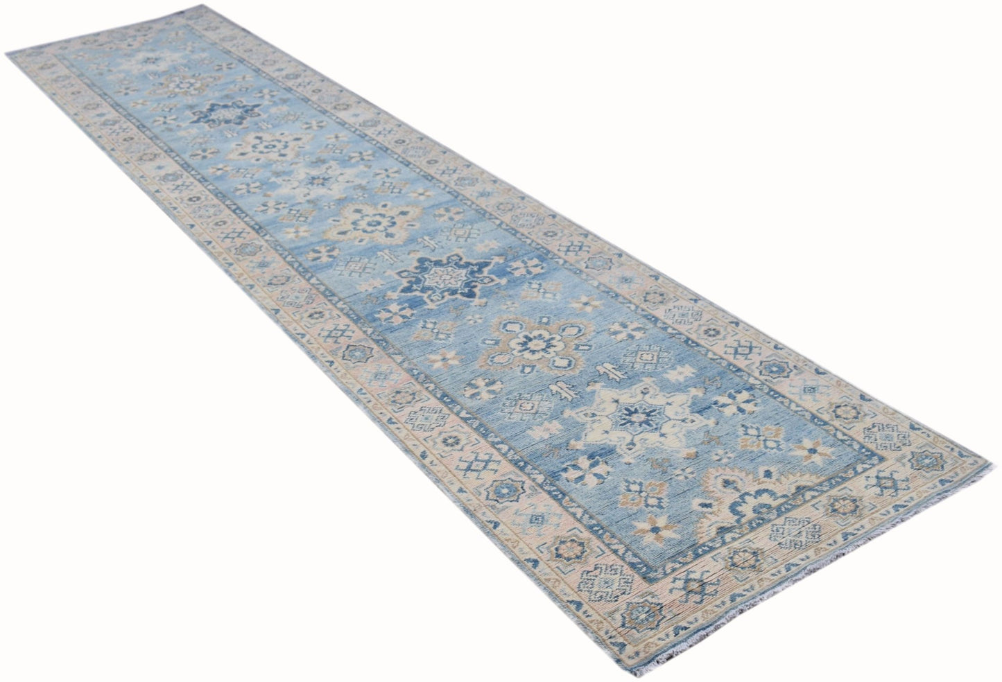 A handmade Afghan Kazakh runner rug featuring traditional blue and beige geometric patterns.