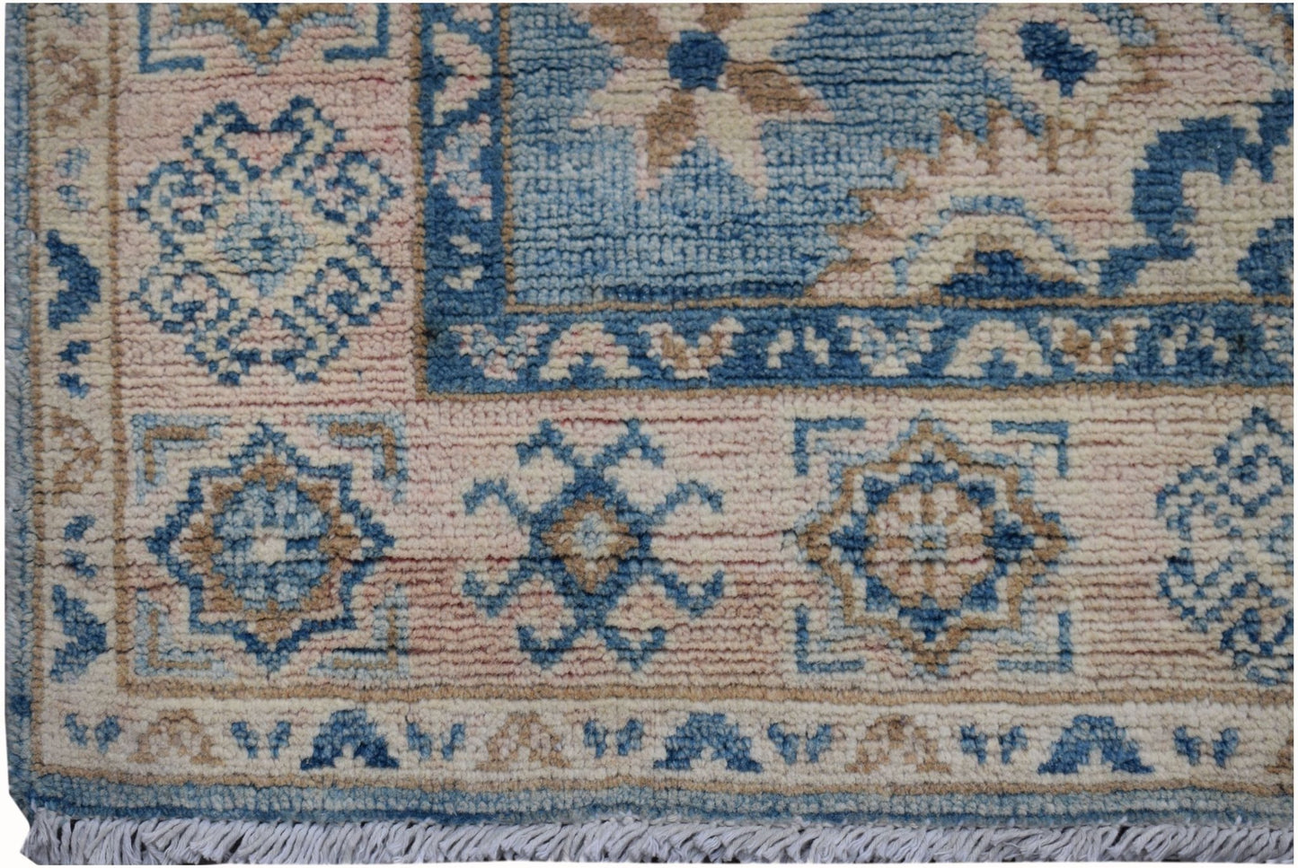 A handmade Afghan Kazakh runner featuring traditional geometric patterns in blue, beige, and pink.