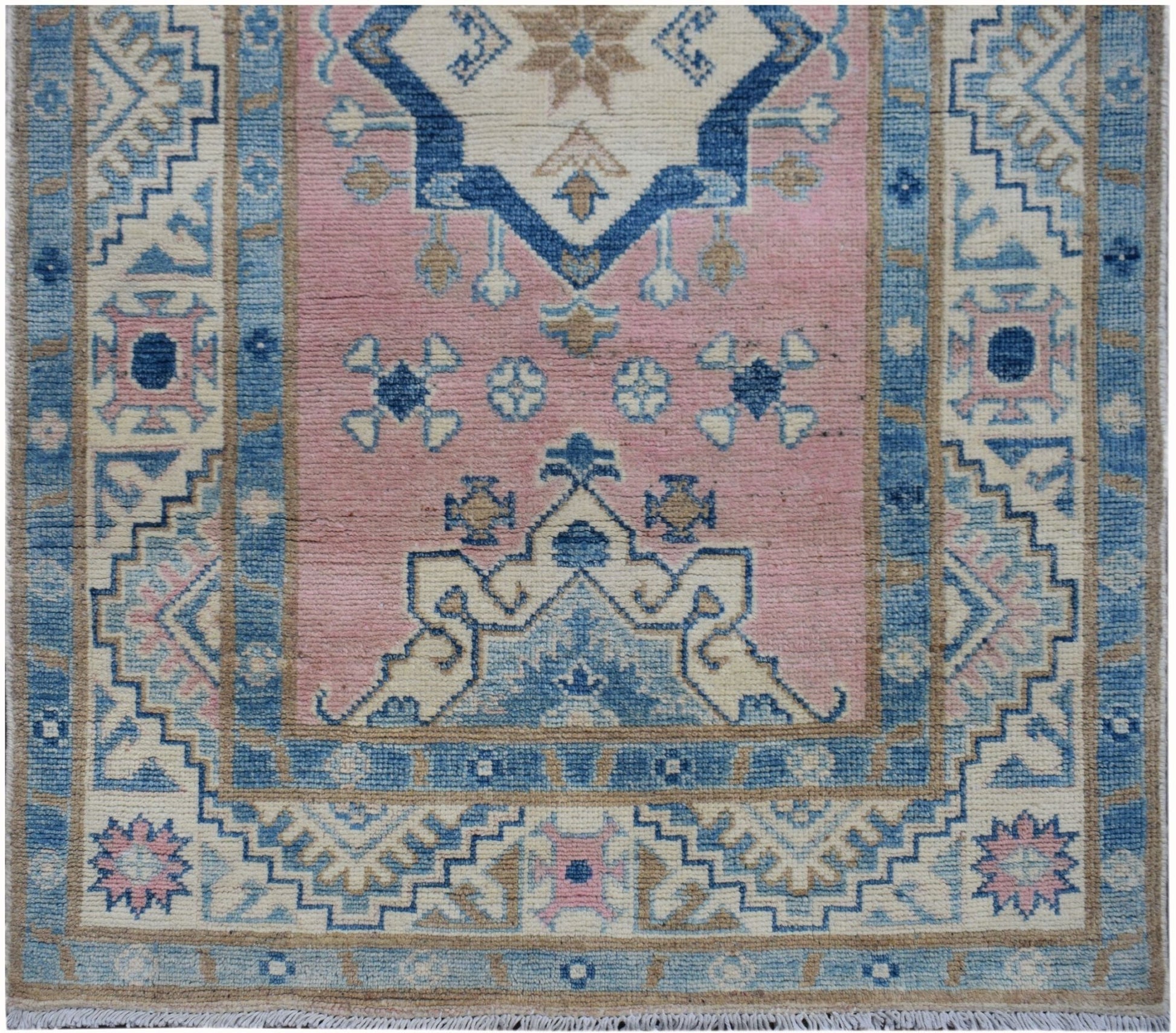Handmade Afghan Kazakh runner featuring a geometric pattern in shades of pink, blue, and beige.