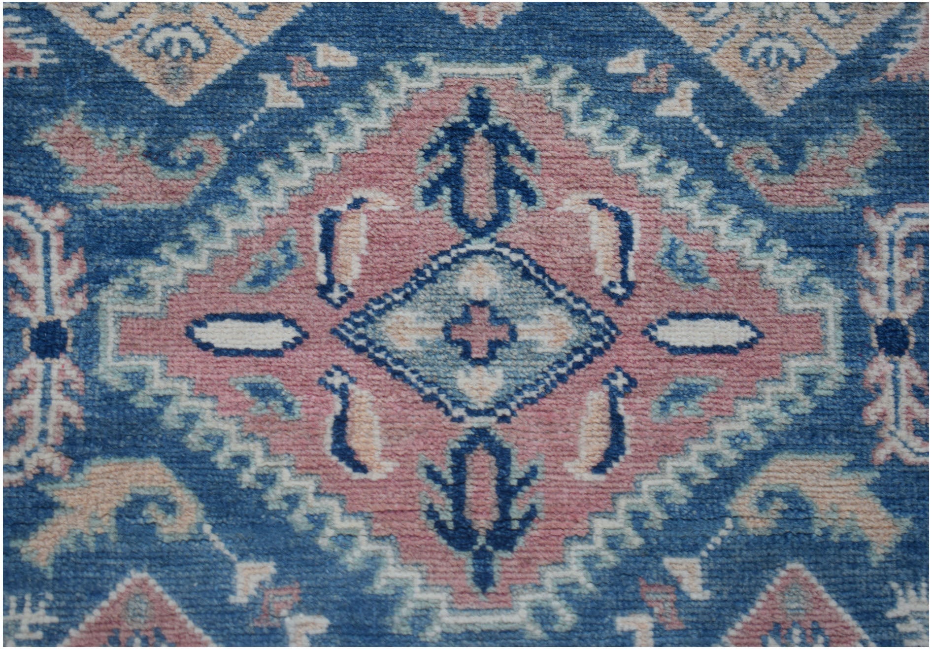 Handmade Afghan Kazakh runner featuring a geometric diamond pattern in blue, pink, and cream.