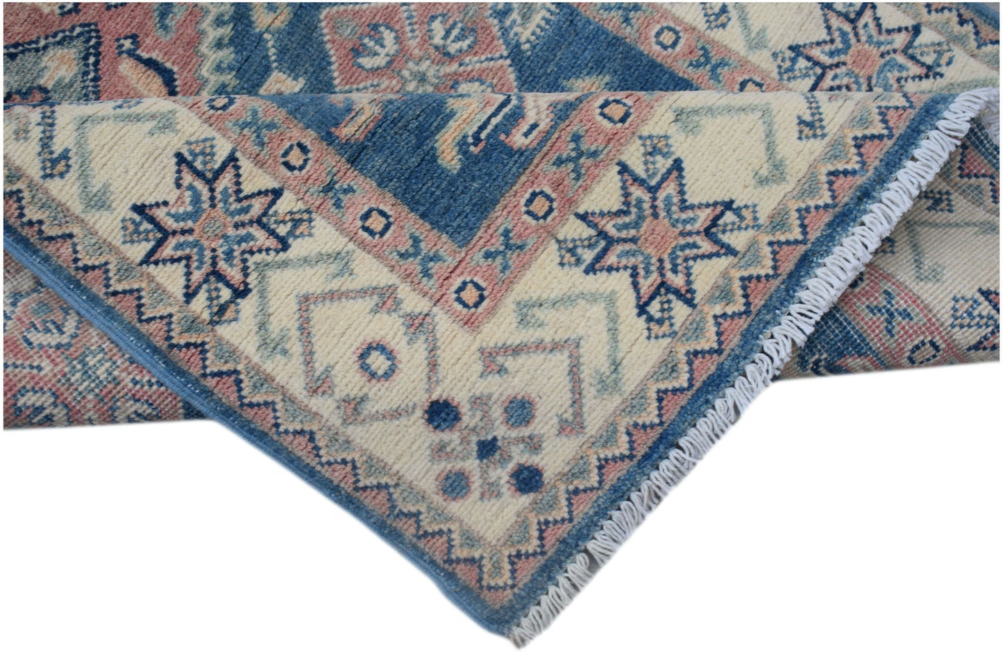 A handmade Afghan Kazakh runner featuring traditional geometric motifs in blue, pink, and cream.