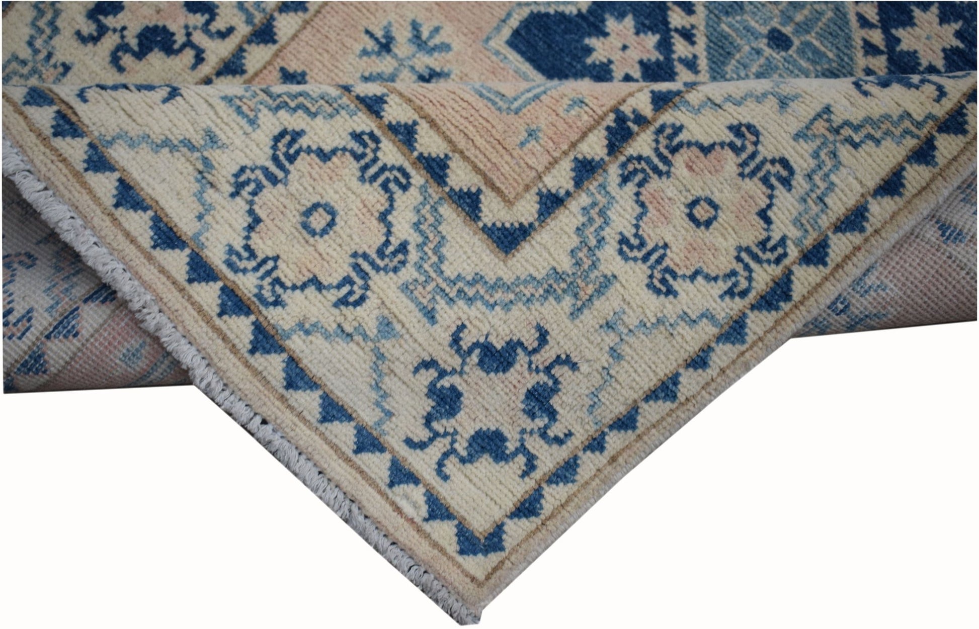 A handmade Afghan Kazakh runner featuring a geometric pattern in blue and beige wool.