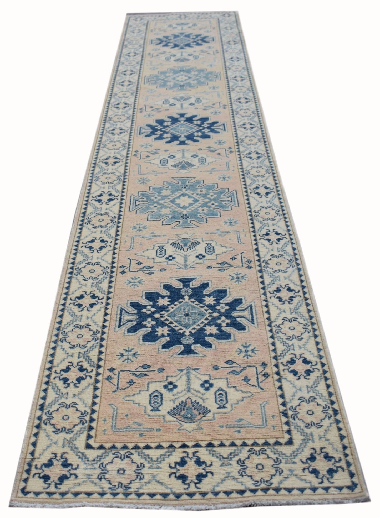 Handmade Afghan Kazakh runner rug featuring a geometric pattern in blue and beige tones.