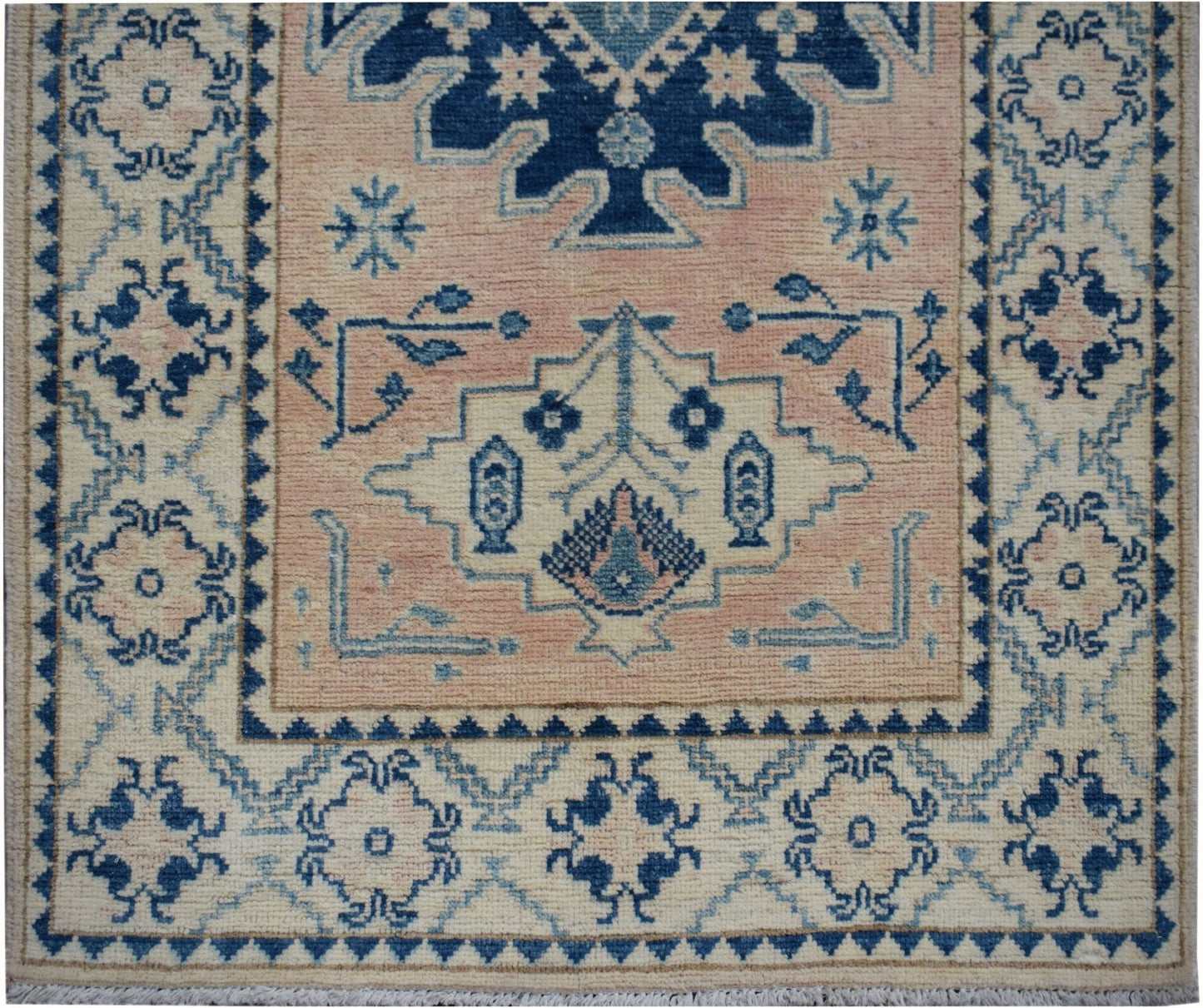 Handmade Afghan Kazakh runner featuring a geometric floral pattern in blue on a beige background.