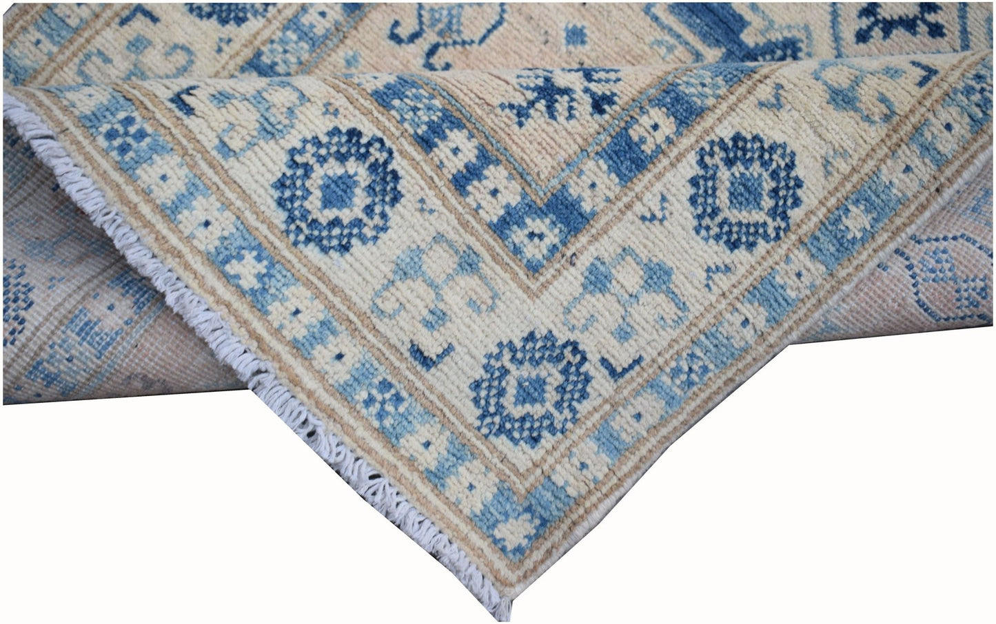 A handmade Afghan Kazakh runner rug featuring a geometric pattern in shades of blue and beige.