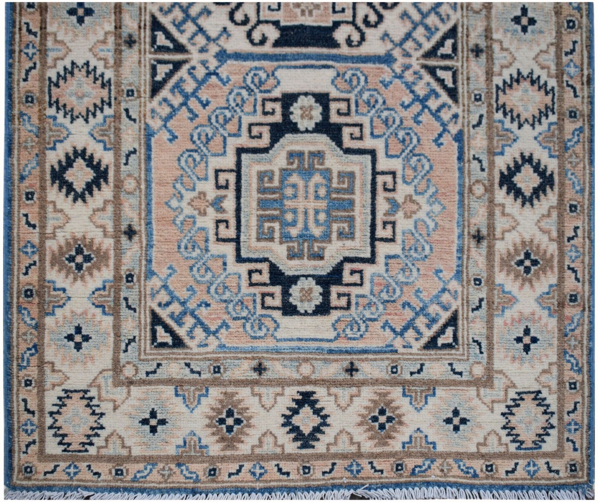 Handmade Afghan Kazakh runner rug featuring a geometric medallion pattern in blue and beige.