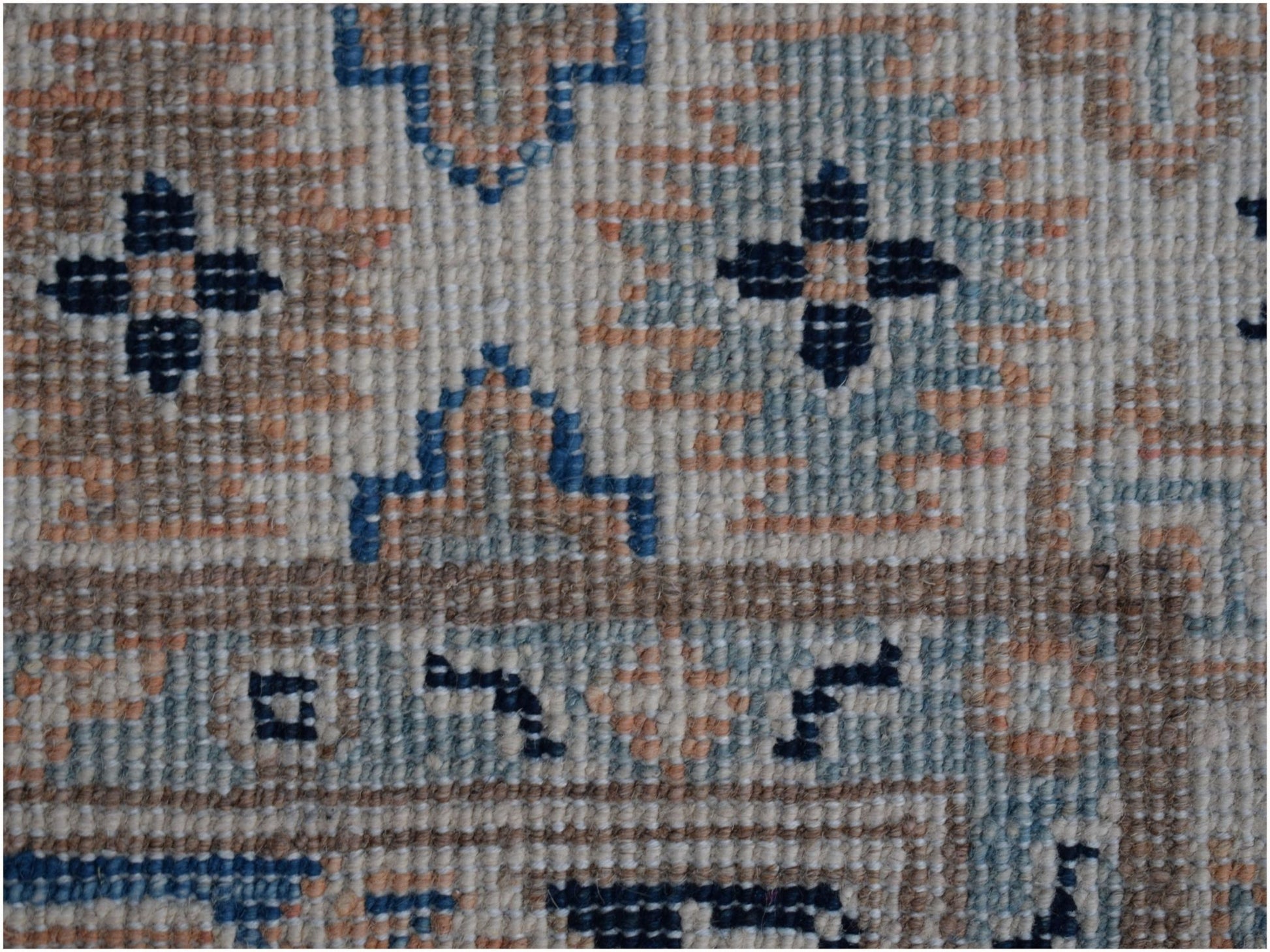 A handmade Afghan Kazakh runner rug featuring a geometric pattern in beige, blue, and grey tones.