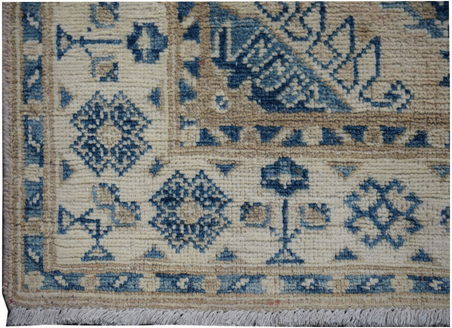 Handmade Afghan Kazakh runner featuring a traditional blue and beige geometric floral pattern.