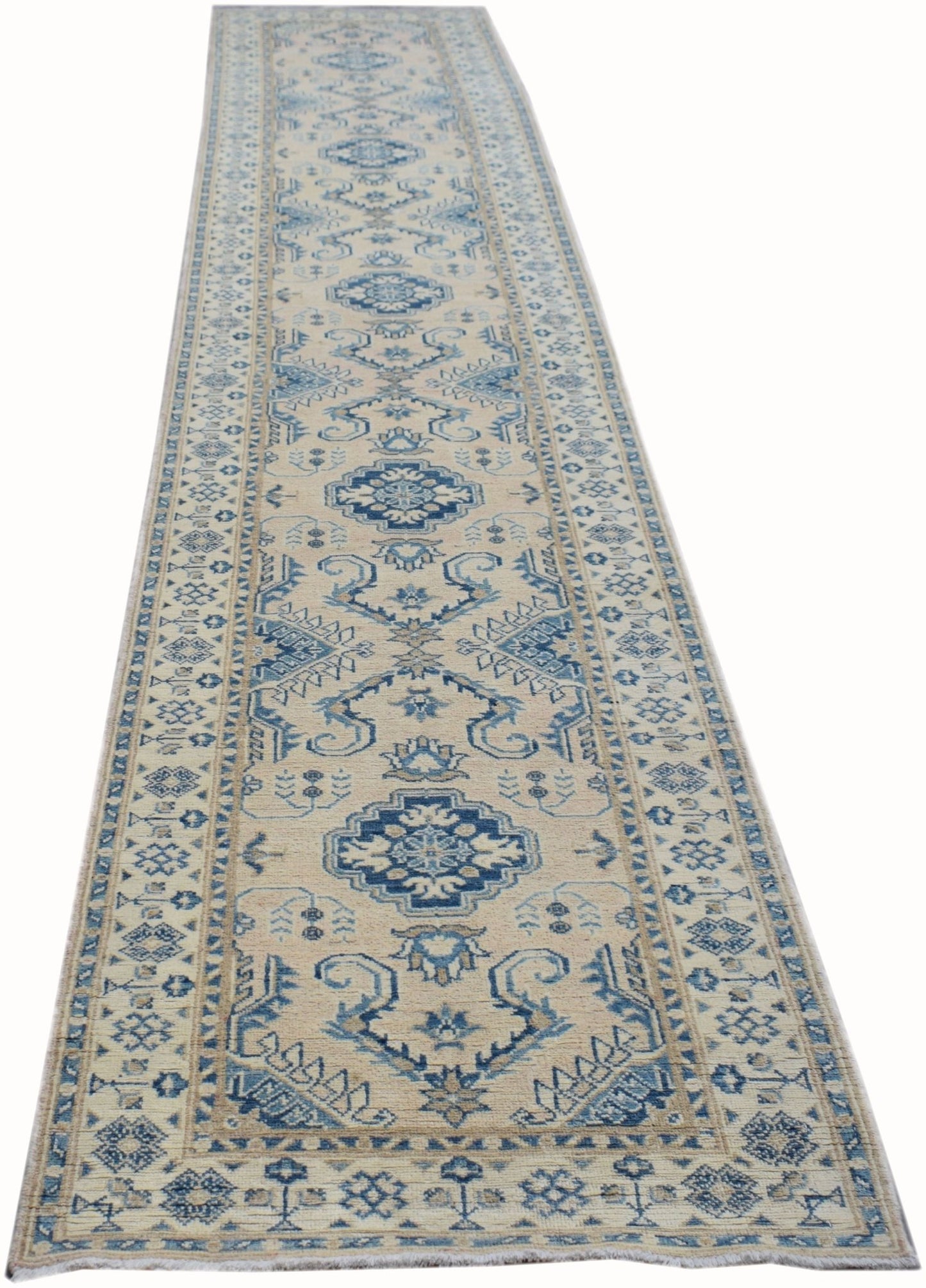 A handmade Afghan Kazakh runner rug featuring a traditional blue and beige geometric pattern.