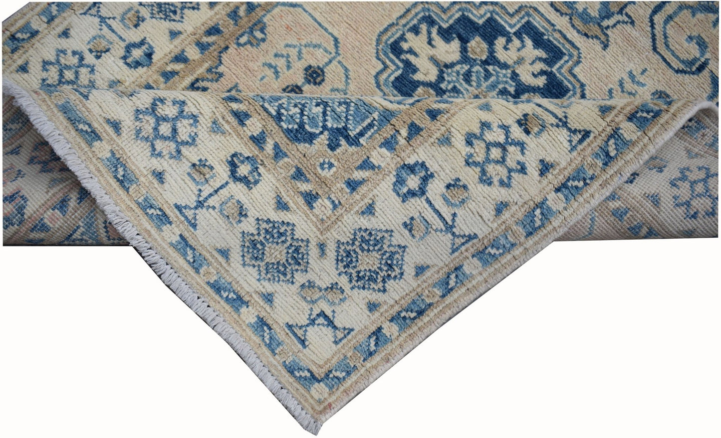 A handmade Afghan Kazakh runner rug featuring a beige background with blue geometric patterns.