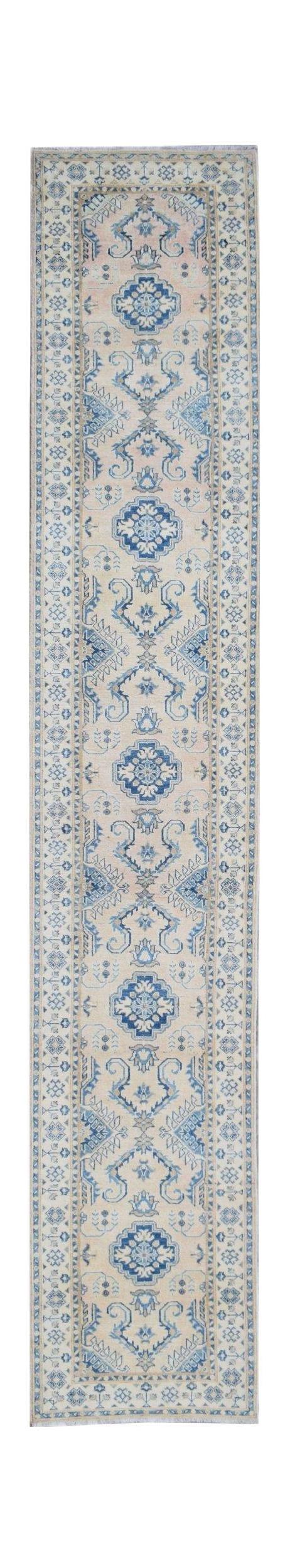 Handmade Afghan Kazakh runner rug featuring a beige field with blue and grey geometric motifs.