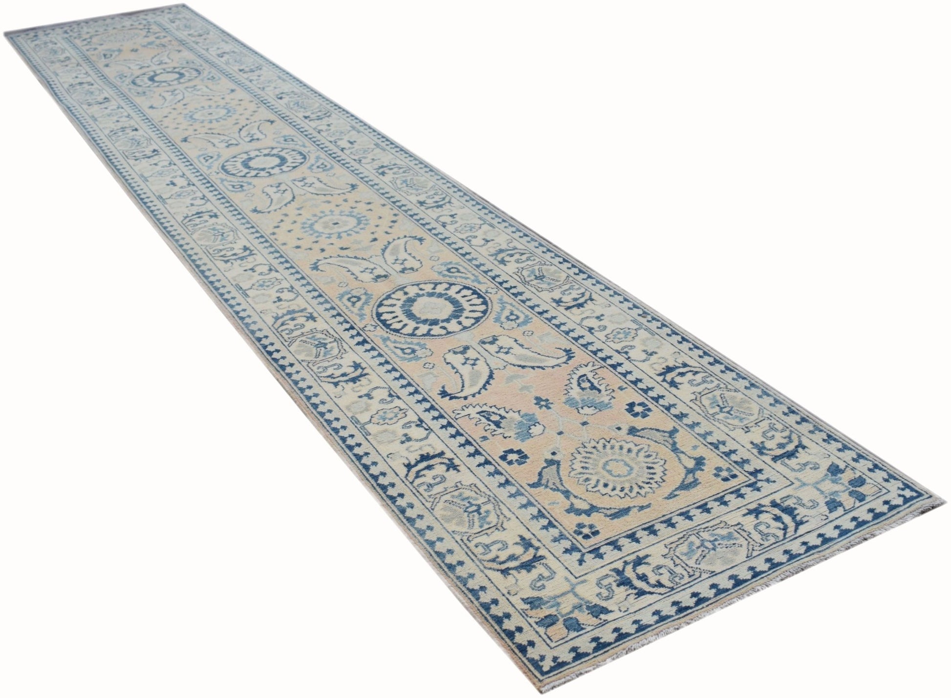 An Afghan Kazakh runner rug featuring a traditional blue and beige floral pattern.