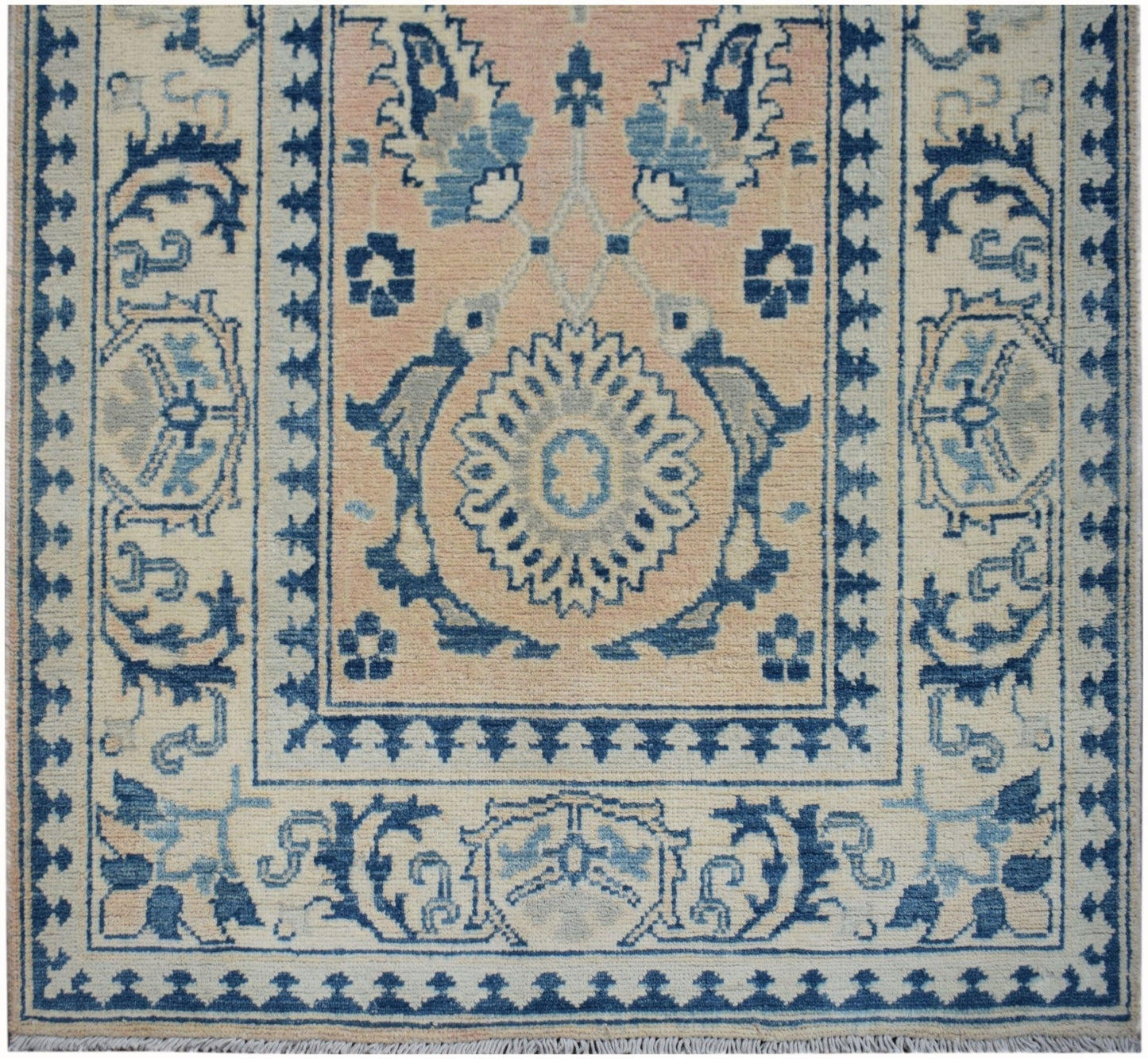 Handmade Afghan Kazakh runner featuring a central floral medallion in blue and beige tones.