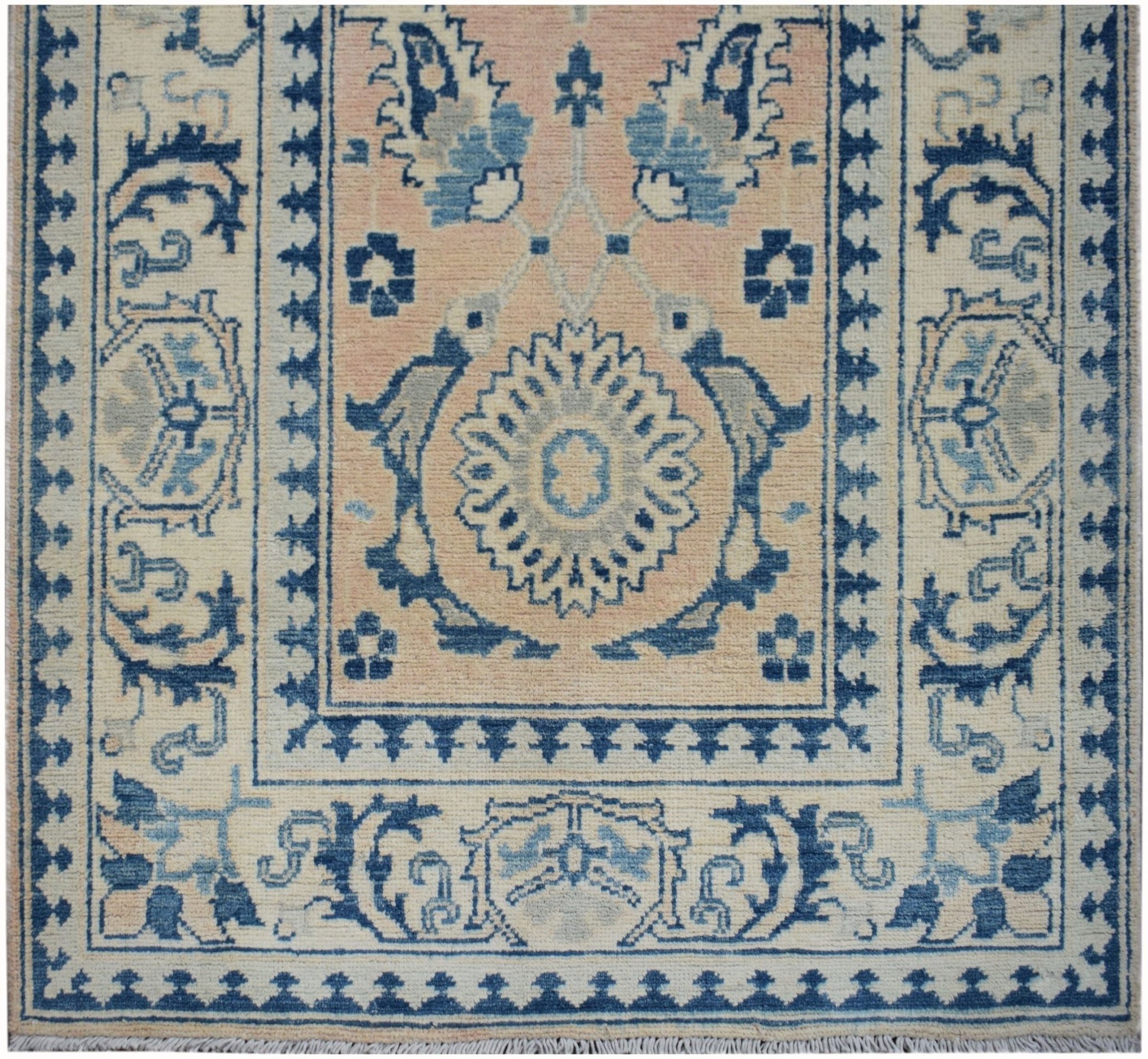Handmade Afghan Kazakh runner featuring a central floral medallion in blue and beige tones.