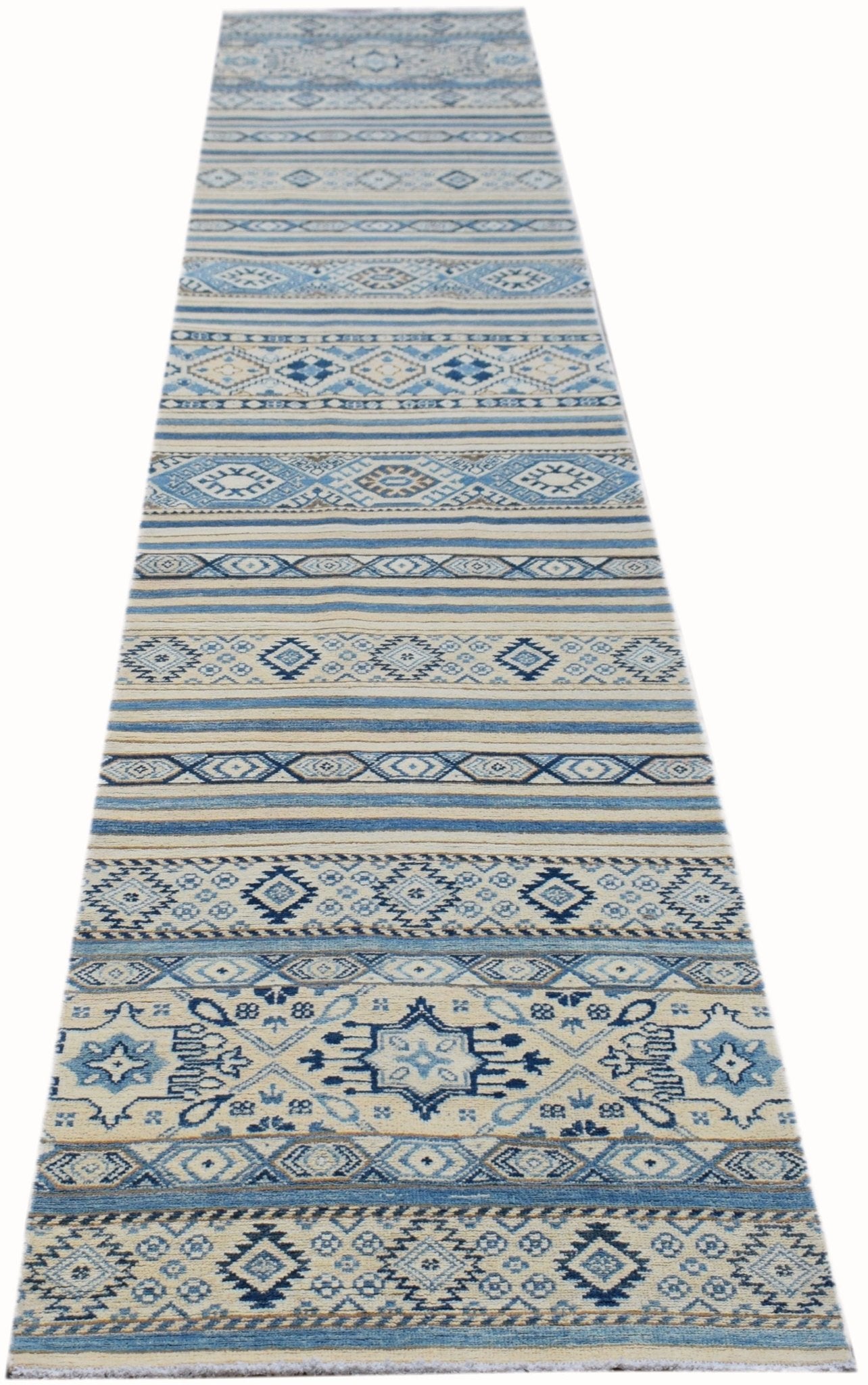A handmade Afghan Kazakh runner rug featuring geometric patterns in shades of blue, grey, and beige.