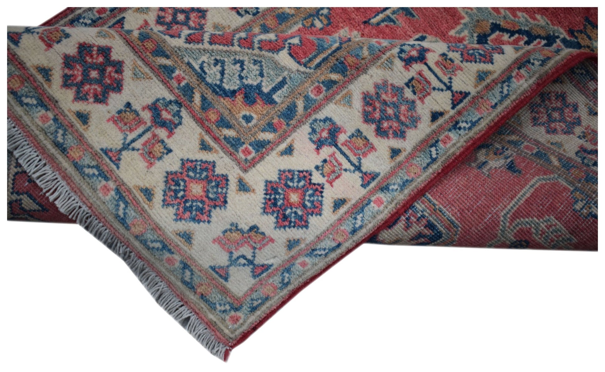 An Afghan Kazakh runner rug featuring traditional geometric motifs in red, blue, and cream.