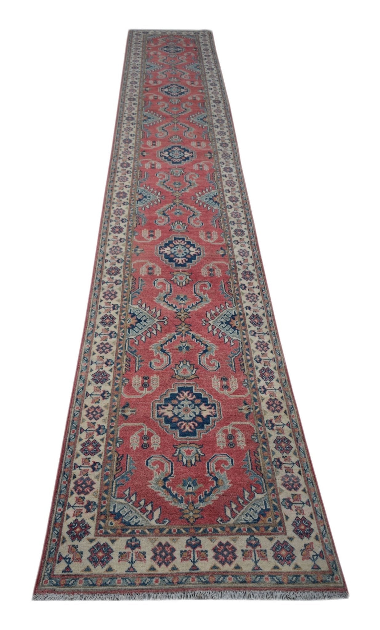 A handmade Afghan Kazakh runner rug featuring traditional geometric motifs in red, blue, and cream.