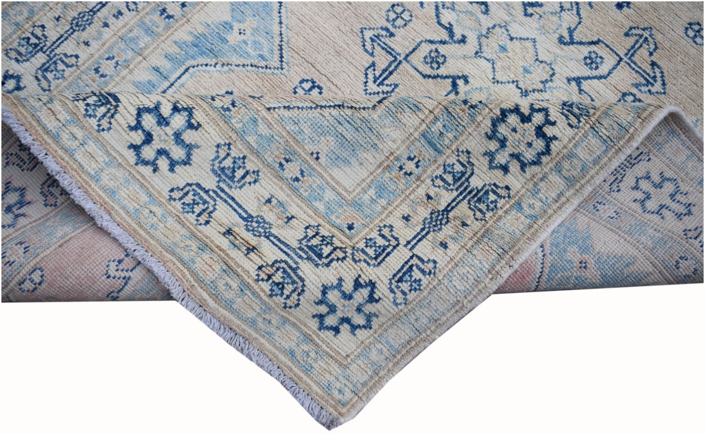A handmade Afghan Kazakh runner rug featuring a geometric blue pattern on a beige wool background.