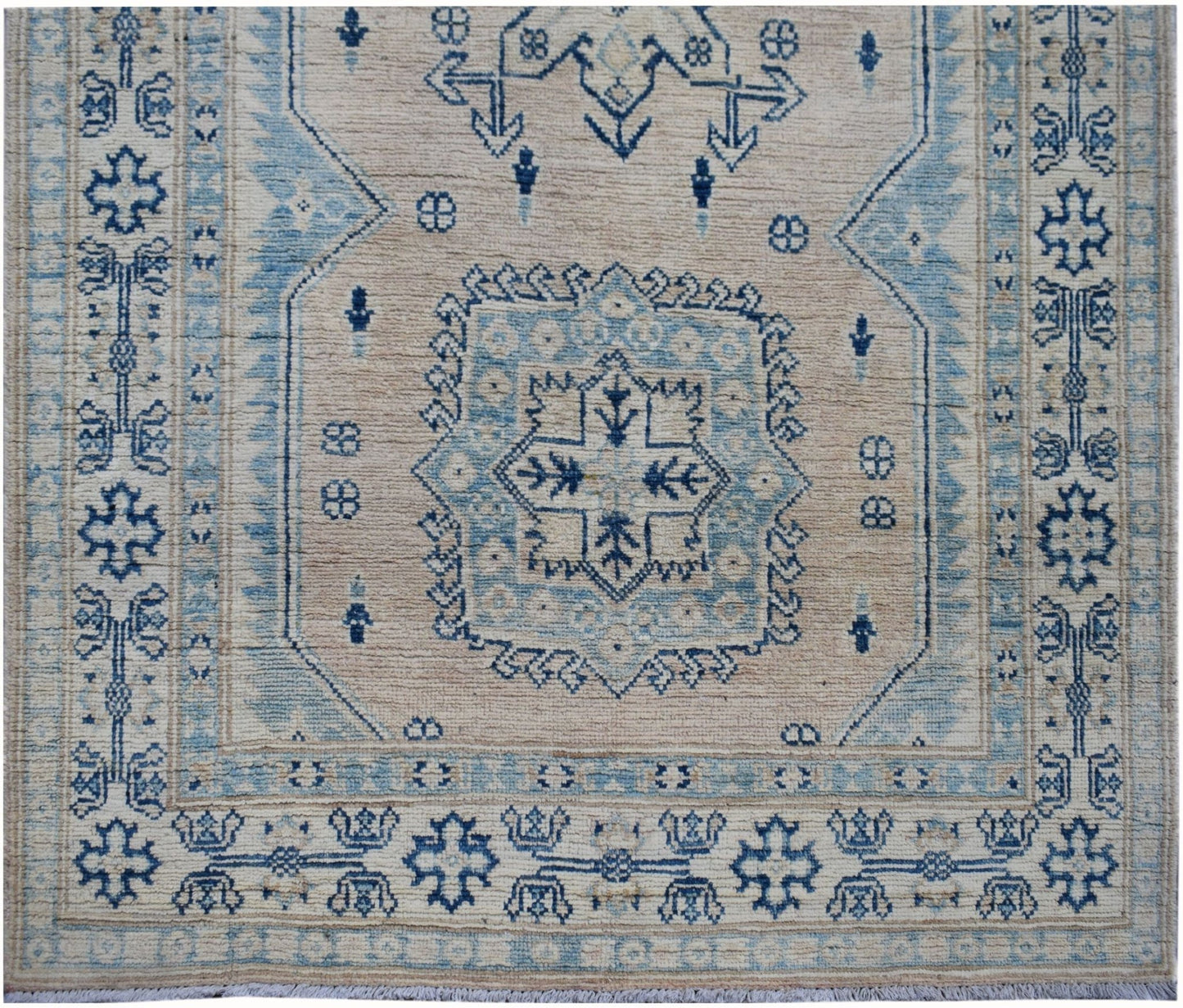 Handmade Afghan Kazakh runner rug featuring a geometric blue and beige pattern.