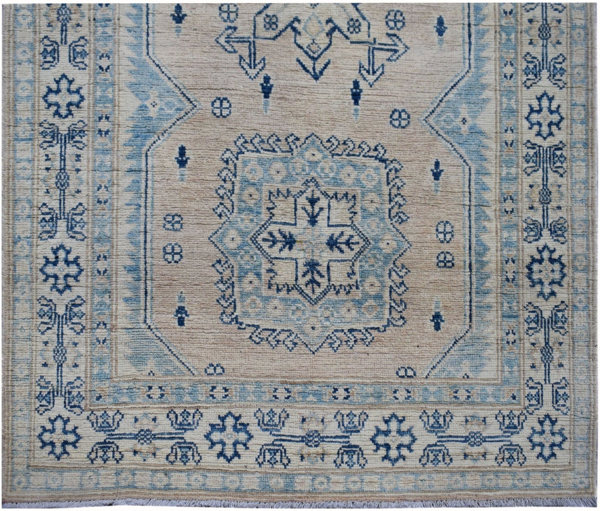 Handmade Afghan Kazakh runner rug featuring a geometric blue and beige pattern.