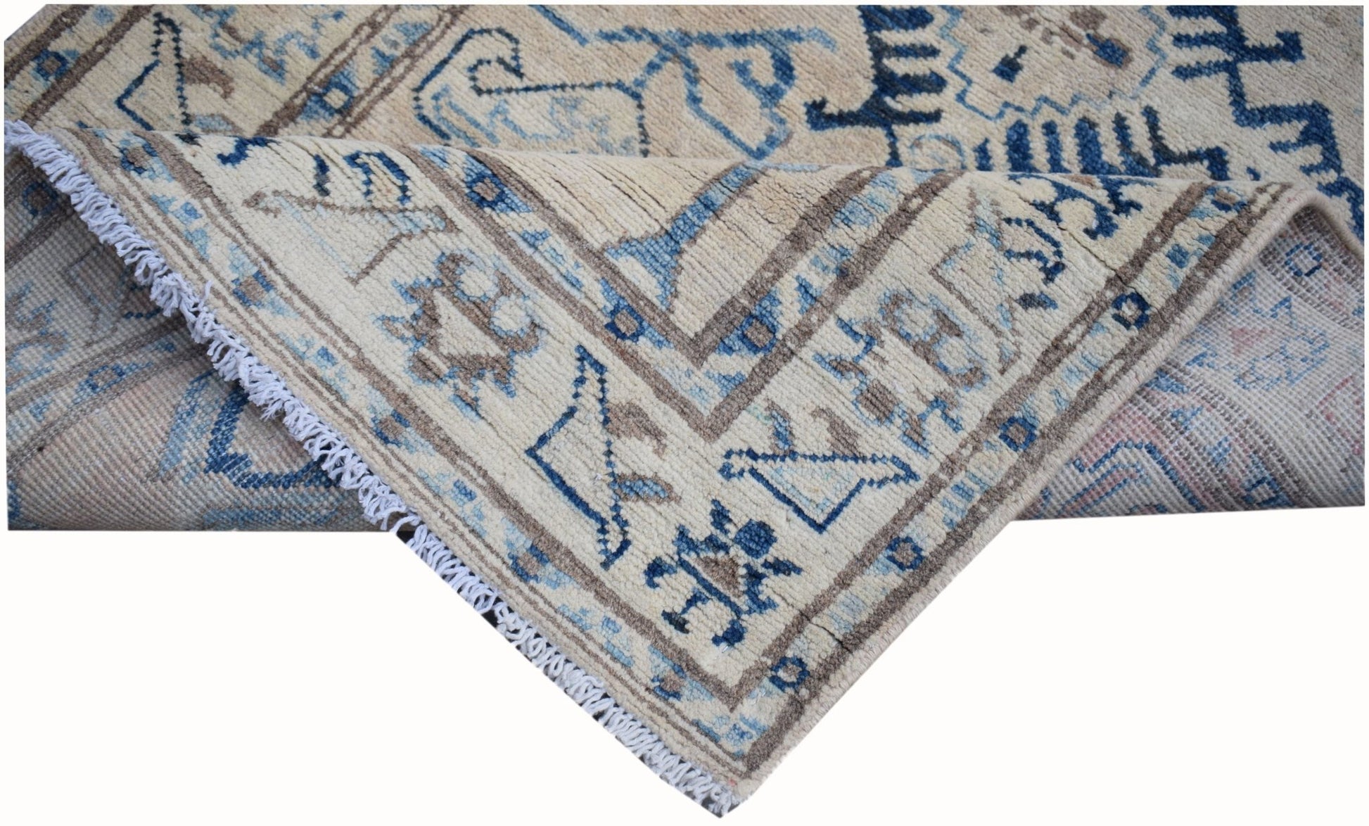 A handmade Afghan Kazakh runner rug featuring a beige background with blue and grey geometric motifs.