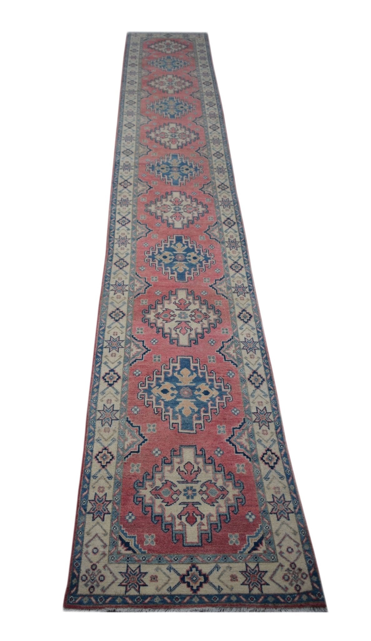 A handmade Afghan Kazakh runner rug featuring traditional geometric motifs in pink, blue, and cream.