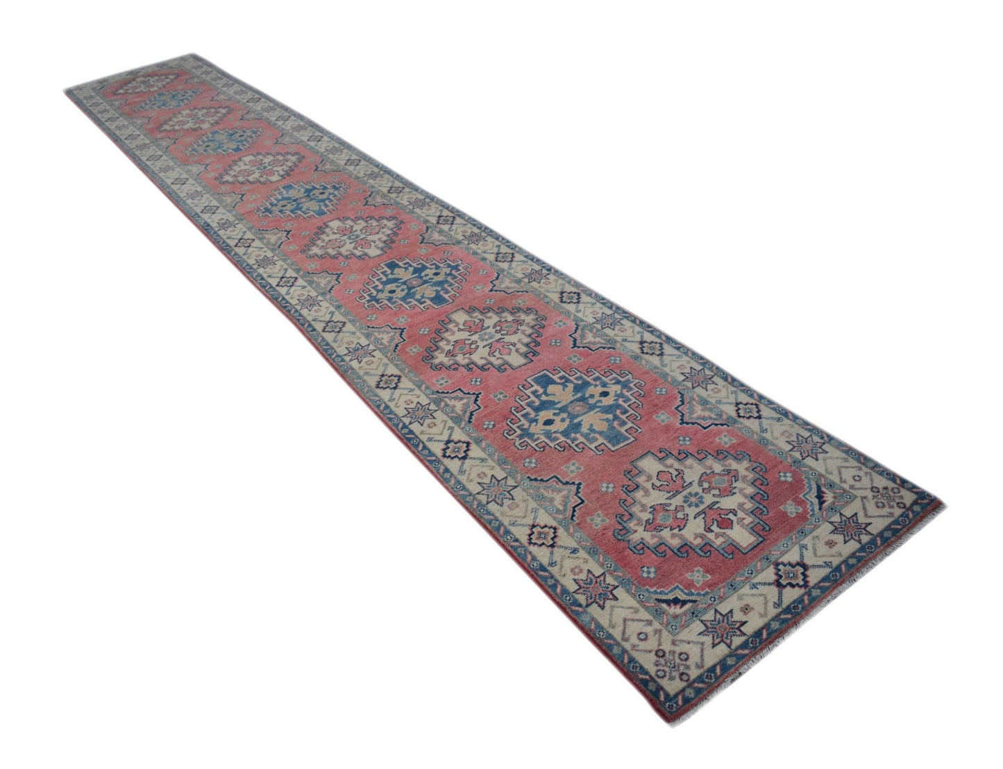 A handmade Afghan Kazakh runner rug featuring traditional geometric motifs in red, blue, and cream.
