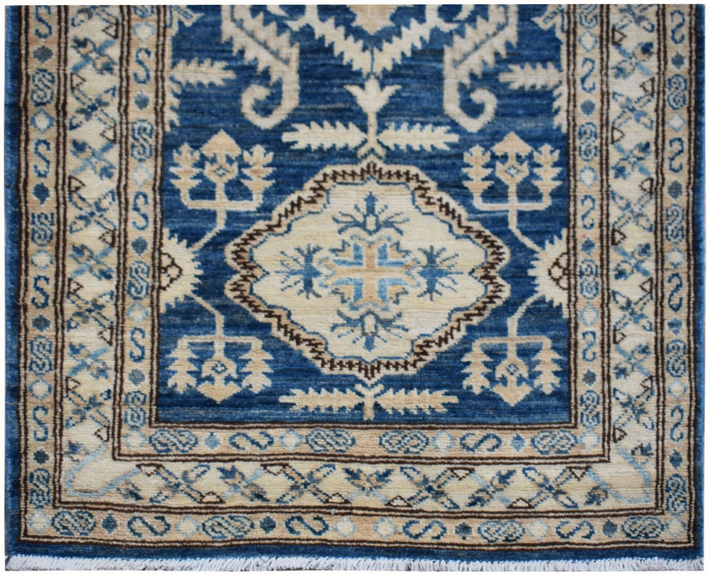 An Afghan Kazakh runner rug featuring a central geometric medallion in blue and beige tones.