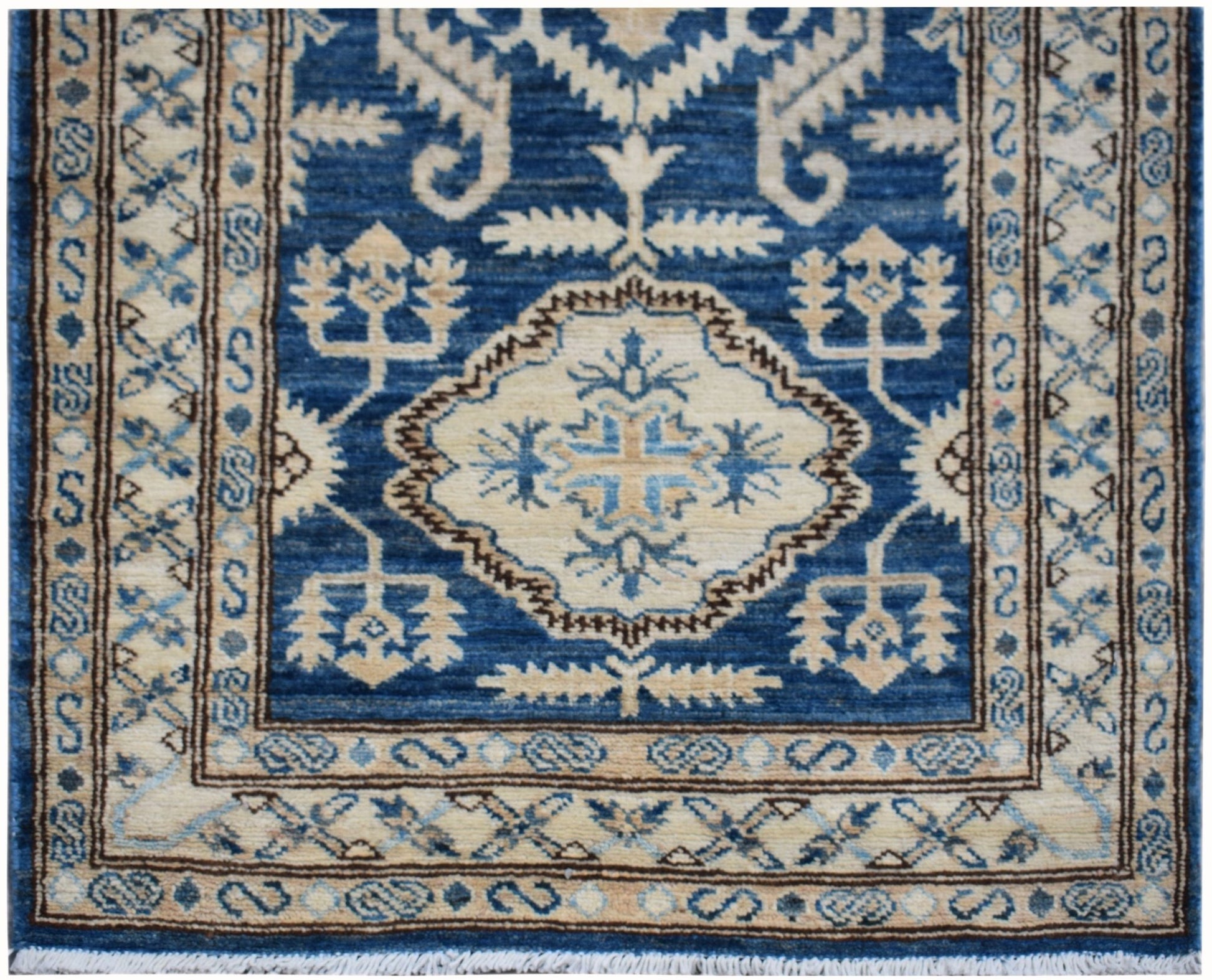 An Afghan Kazakh runner rug featuring a central geometric medallion in blue and beige tones.