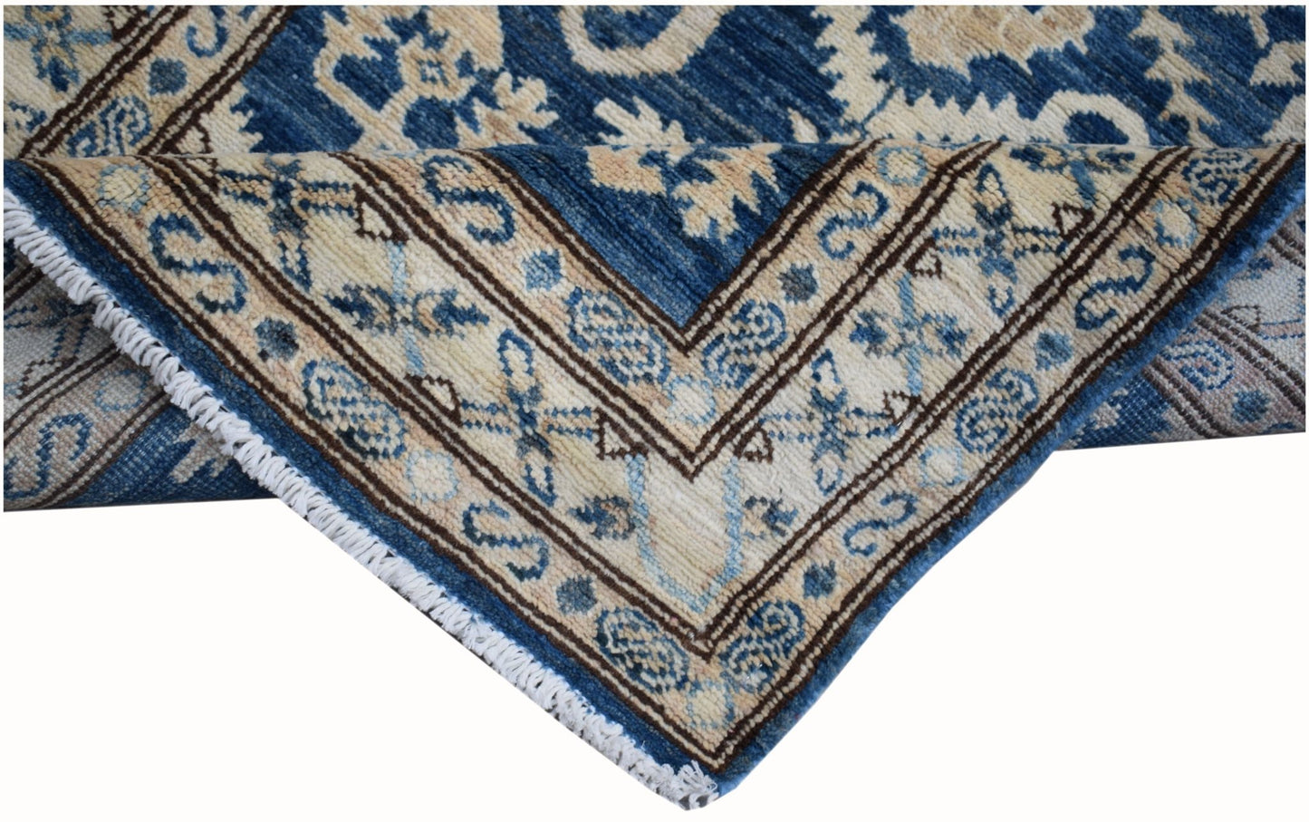 A handmade Afghan Kazakh runner featuring a blue and beige geometric pattern with fringe edges.