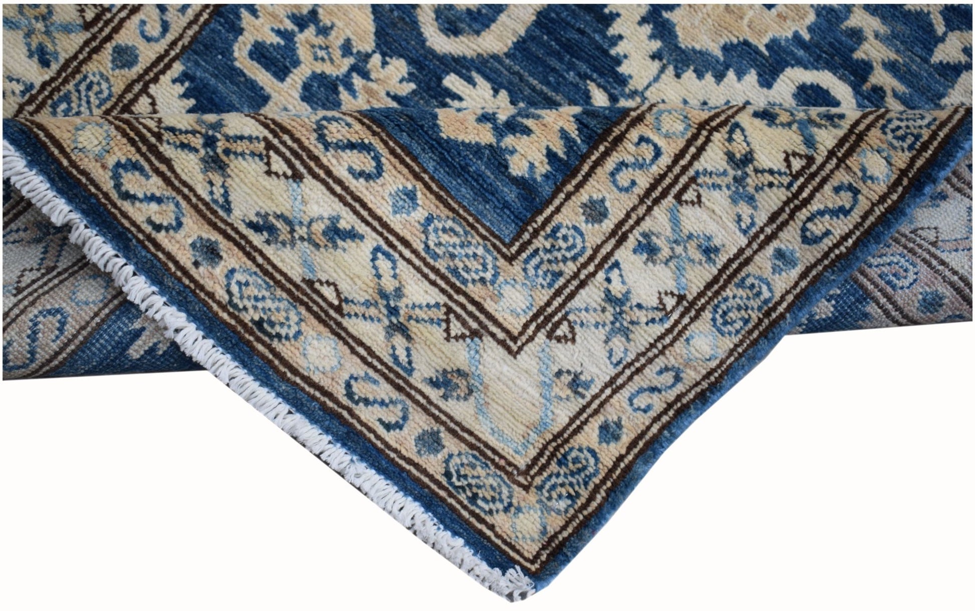A handmade Afghan Kazakh runner featuring a blue and beige geometric pattern with fringe edges.