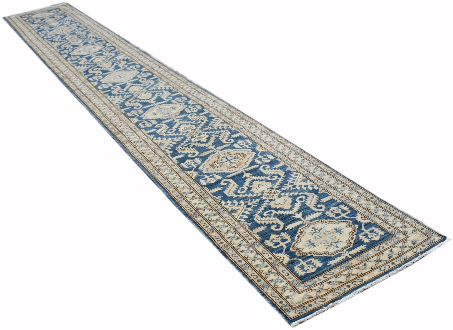 A long, handmade Afghan Kazakh runner rug featuring a blue field with intricate beige patterns.