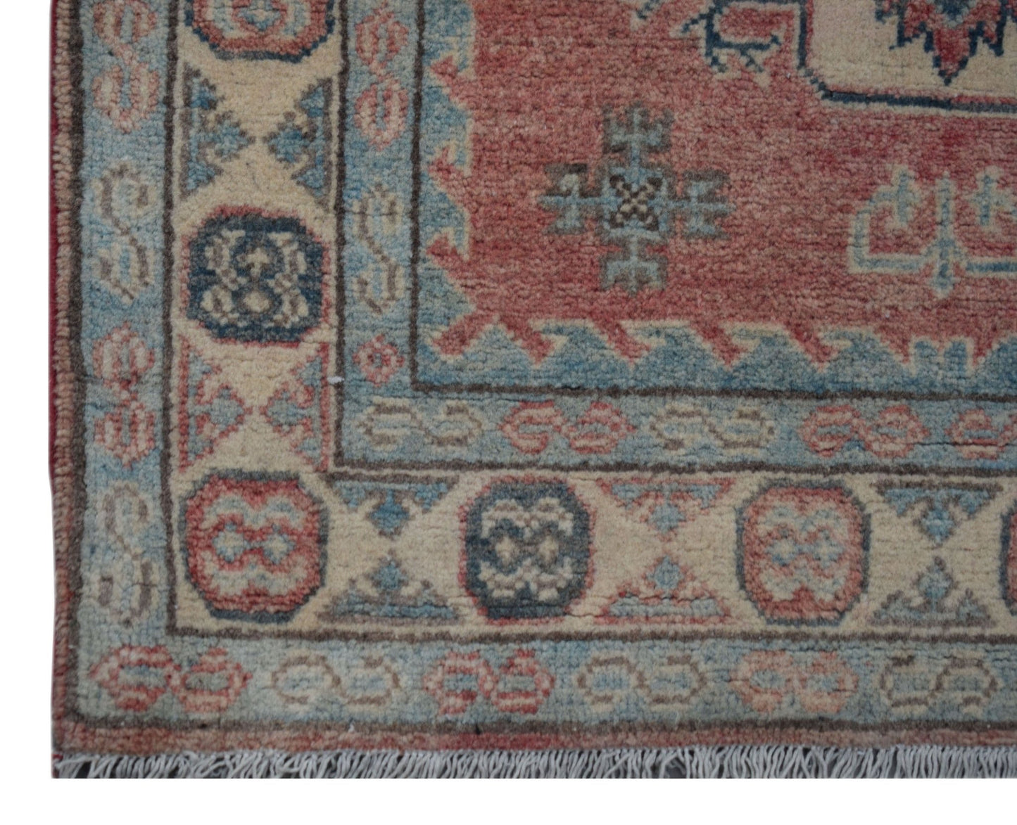 Handmade Afghan Kazakh runner featuring traditional geometric motifs in red, blue, and cream wool.