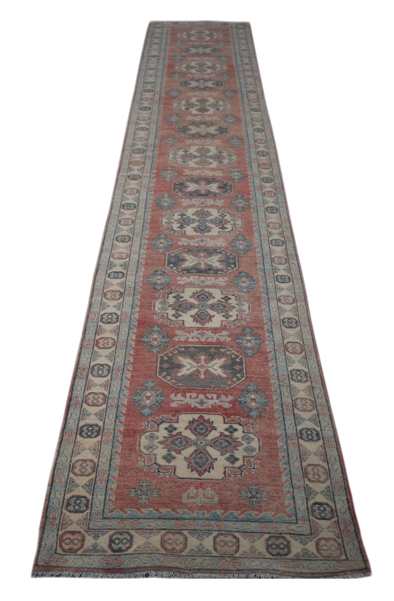 A handmade Afghan Kazakh runner rug featuring traditional geometric motifs in red, blue, and cream.