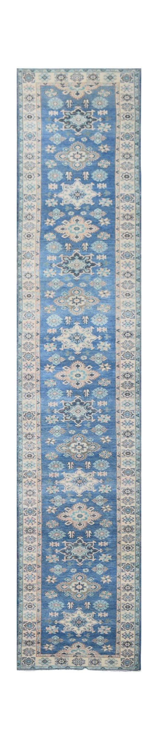 A handmade Afghan Kazakh runner rug featuring a repeating blue floral pattern with beige accents.