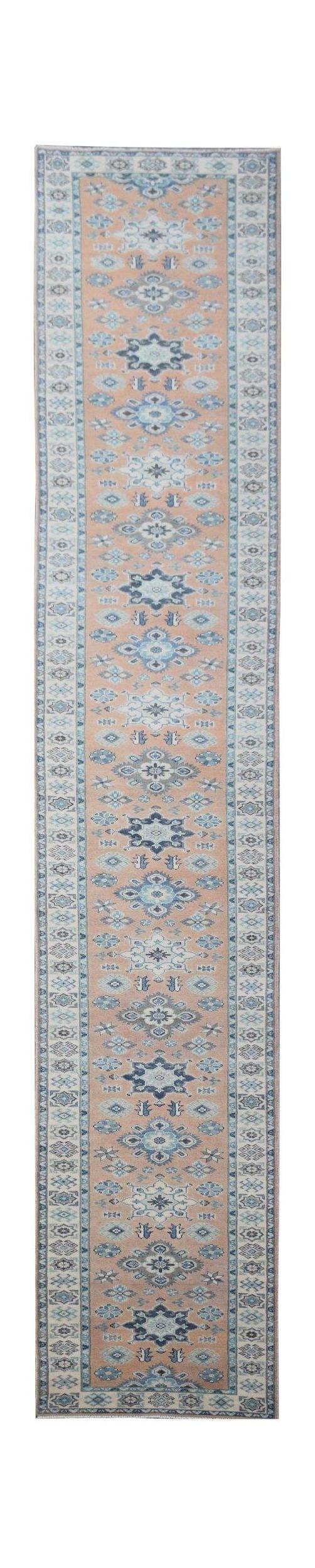 A handmade Afghan Kazakh runner rug featuring a beige field with blue and grey geometric patterns.