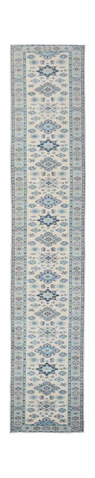 A handmade Afghan Kazakh runner rug featuring a repeating blue and grey geometric pattern on beige.