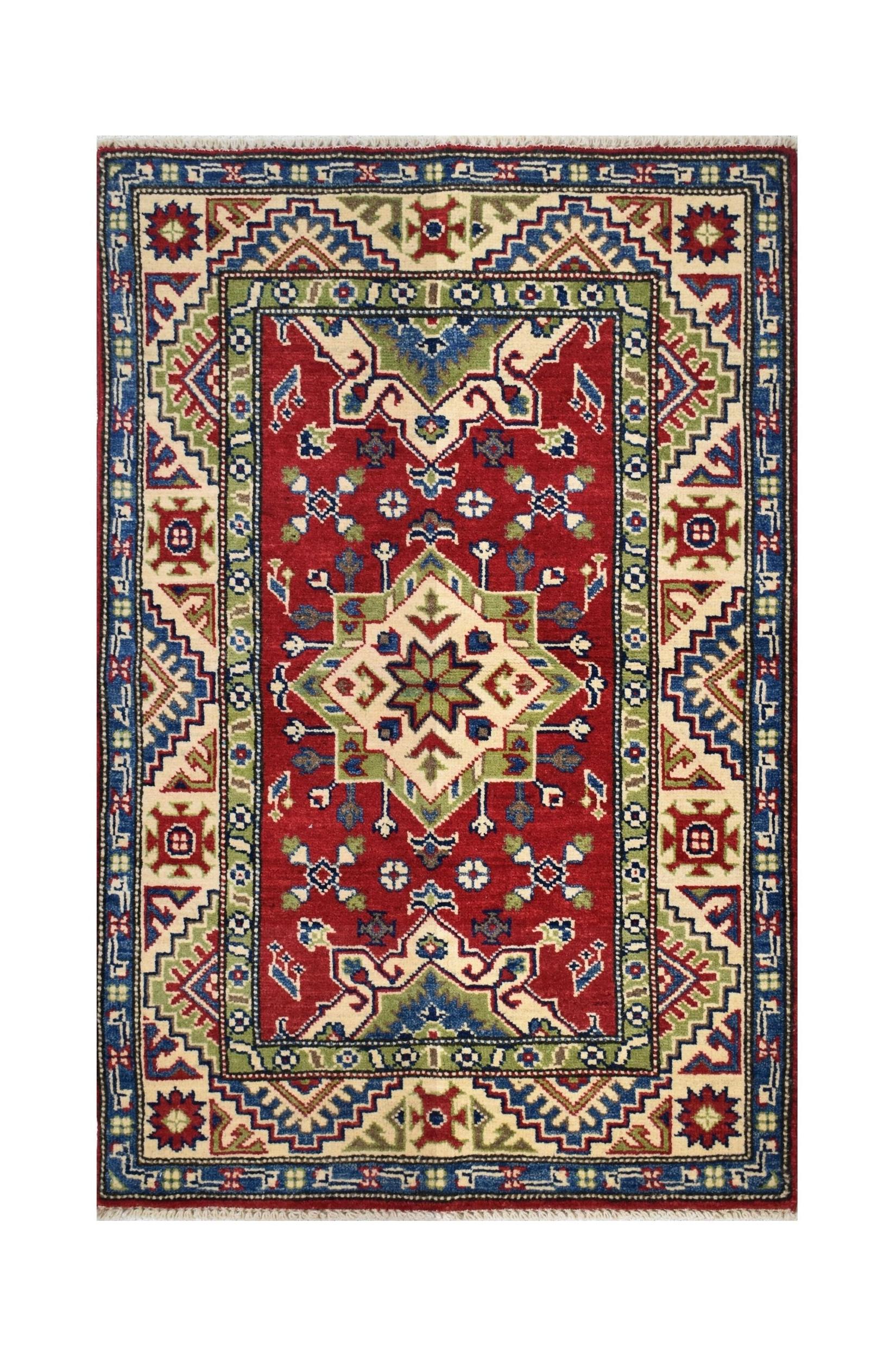 Handmade Afghan Kazakh rug featuring a geometric medallion pattern in red, blue, and green wool.