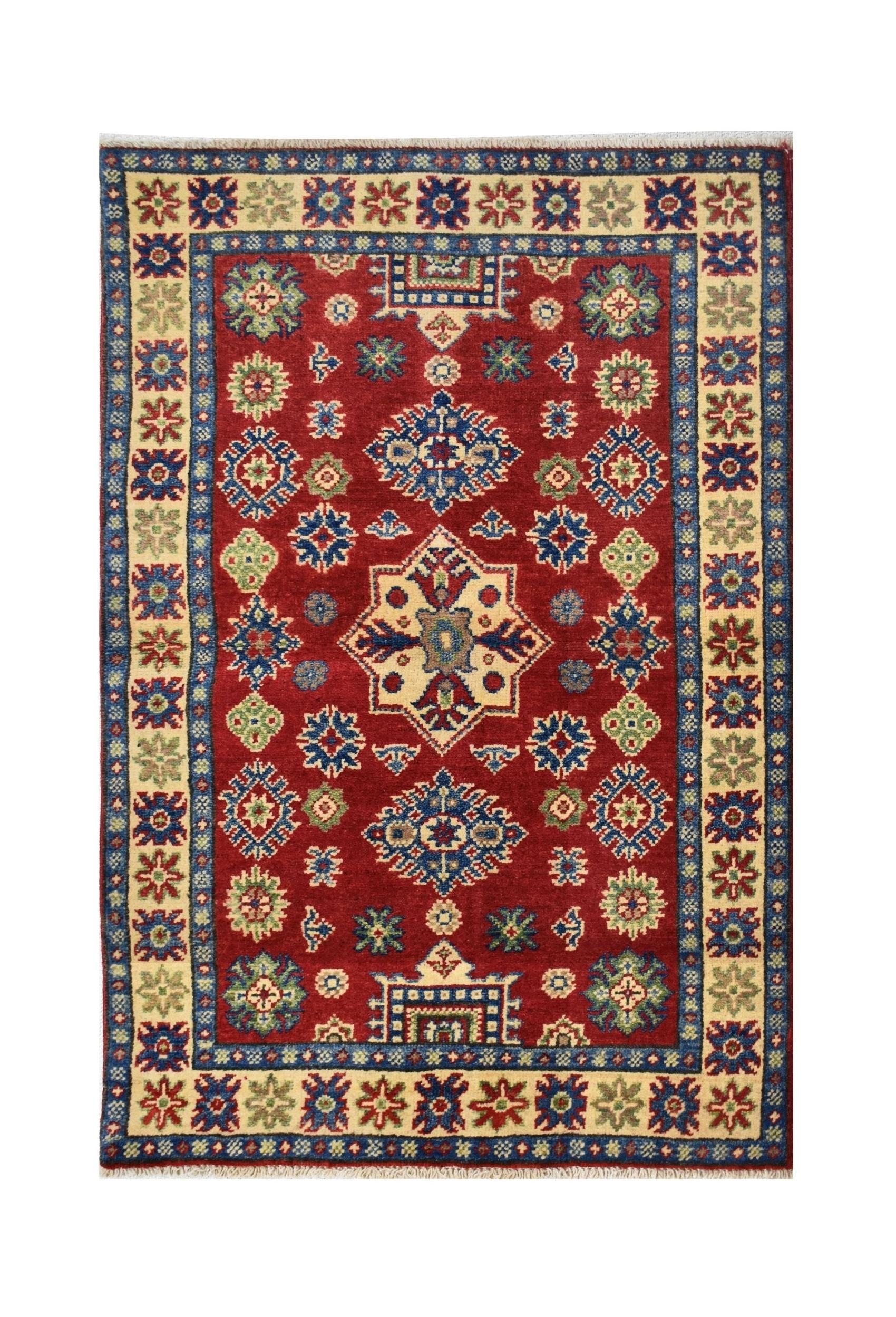 Handmade Afghan Kazakh rug featuring a traditional geometric pattern in red, blue, and cream wool.