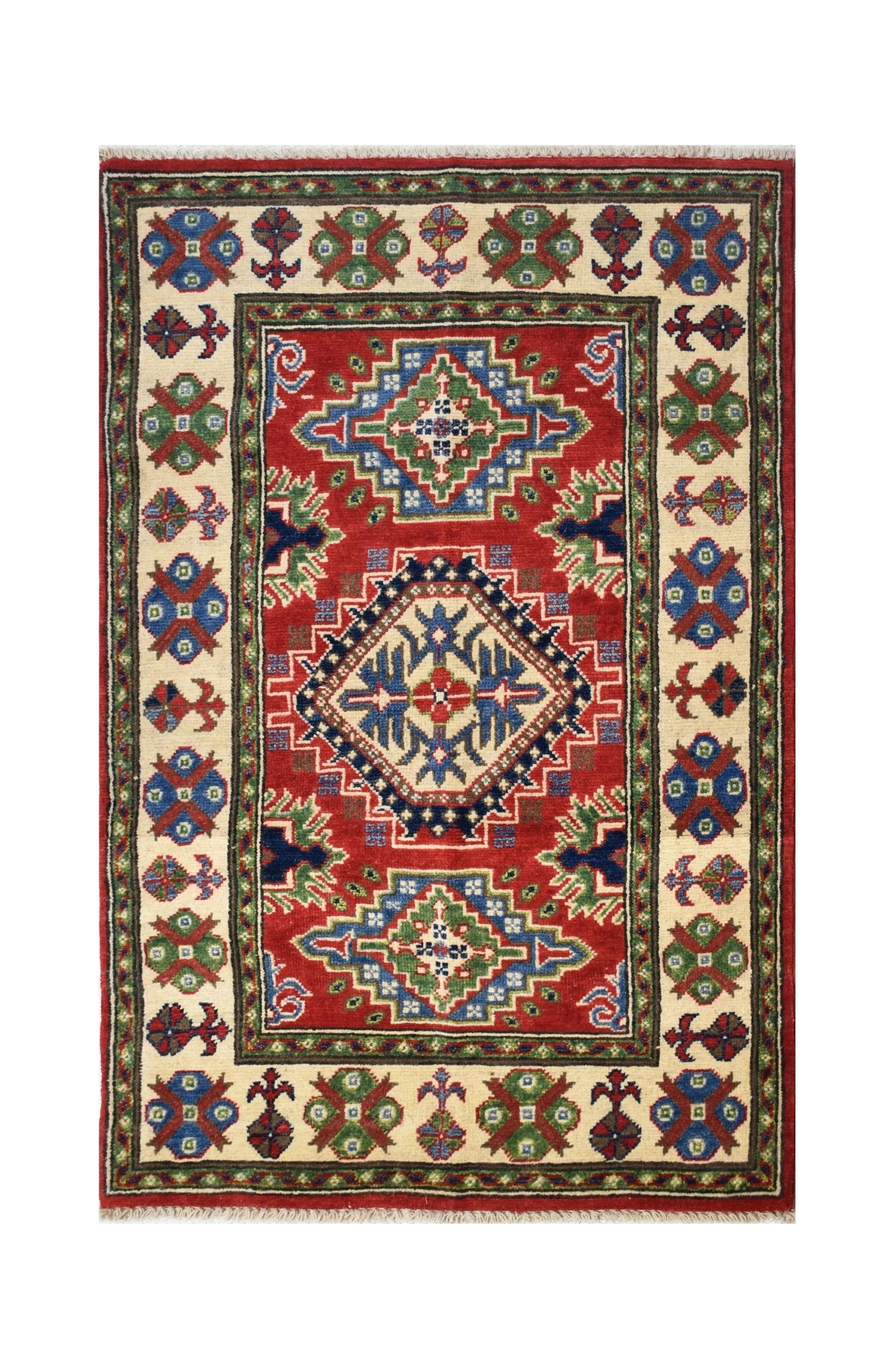 Handmade Afghan Kazakh rug featuring a red field with geometric medallions and a cream border.