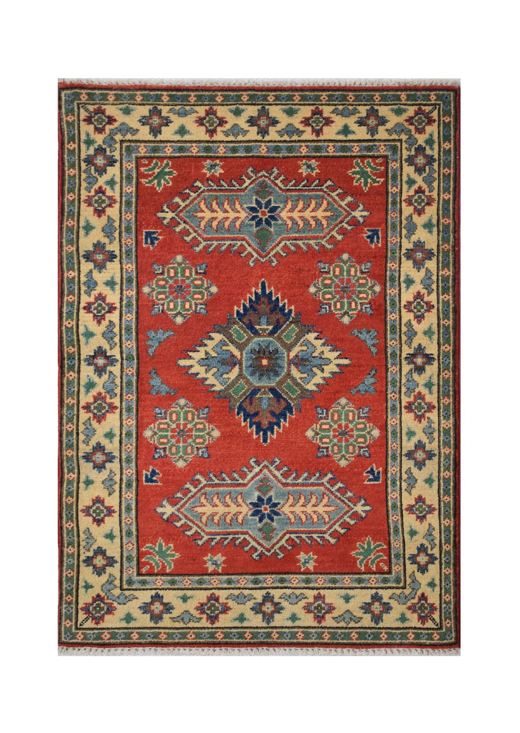Handmade Afghan Kazakh rug featuring a geometric medallion pattern in red, blue, and cream tones.